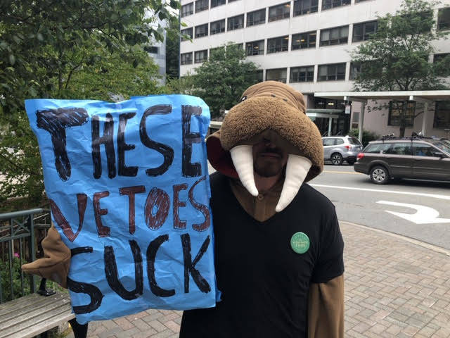 People attend a rally against Gov. Mike Dunleavy’s budget vetoes in front of the Capitol on Friday, July 12, 2019. (Peter Segall | Juneau Empire)