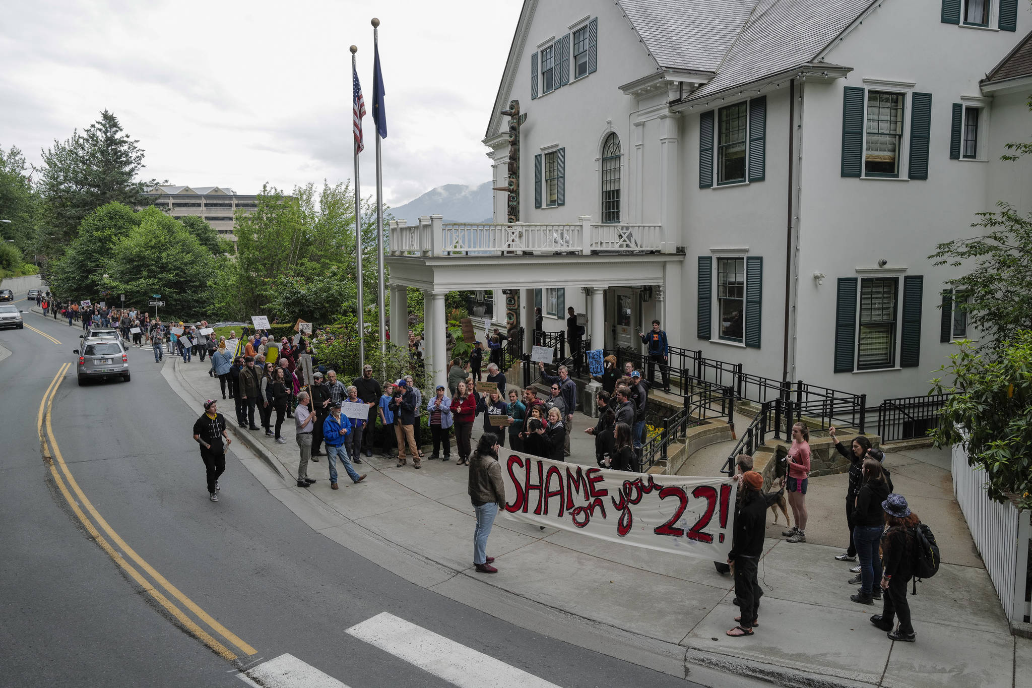 Over hundred people gather in front of the Governor’s Mansion to protest budget vetoes by Gov. Mike Dunleavy on Friday, July 12, 2019. (Michael Penn | Juneau Empire)
