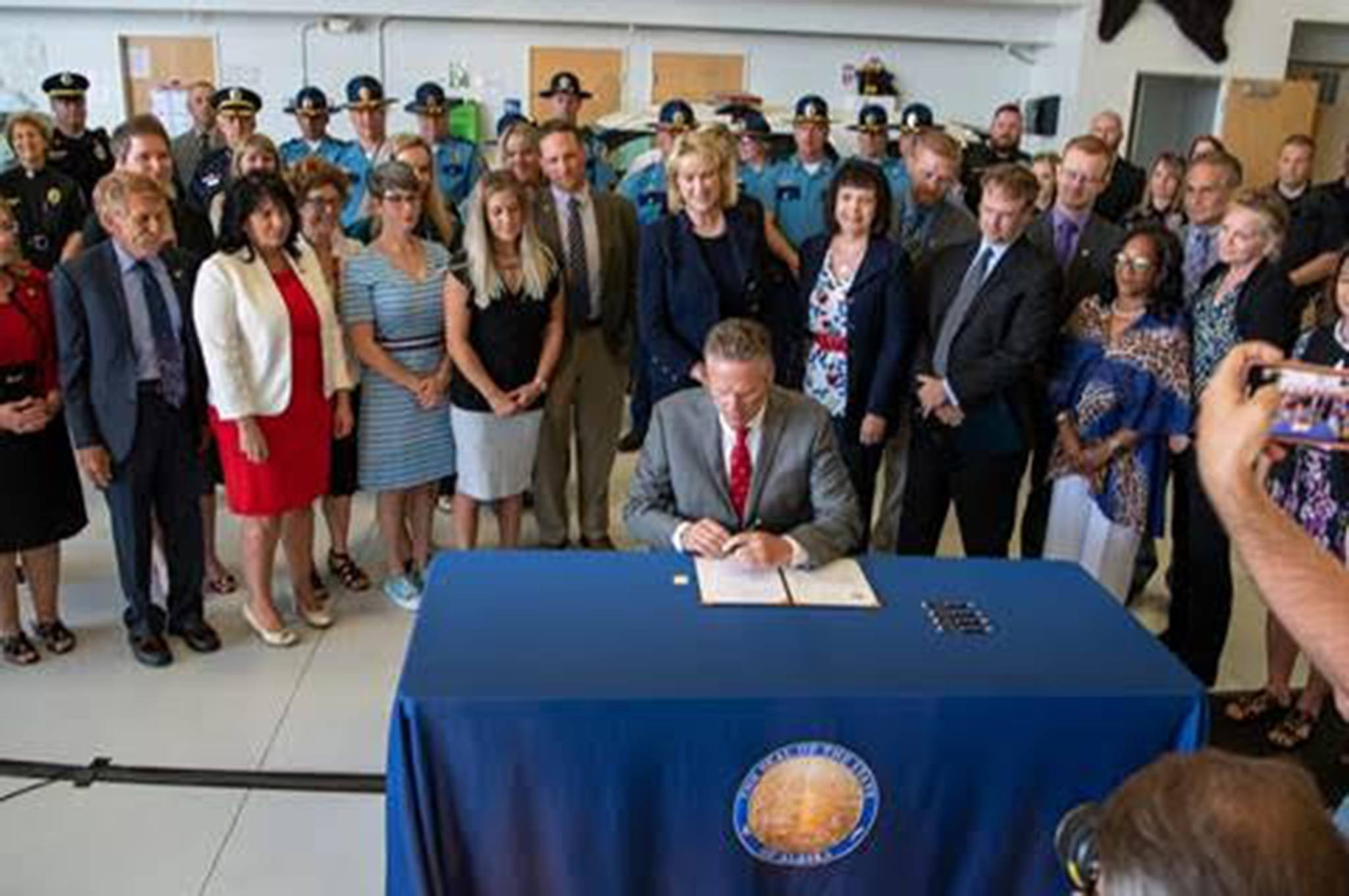 Gov. Mike Dunleavy speaks at the House Bill 49 bill signing ceremony at the Alaska Department of Public Safety Hangar in Anchorage on July 8, 2019. (Courtesy photo | Governors office)
