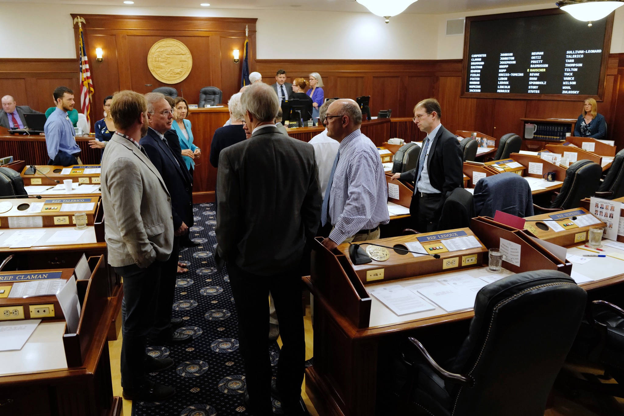 Lawmakers talk among themselves during a break of a joint session of the Alaska Legislature Thursday, July 11, 2019, in Juneau, Alaska. Lawmakers are meeting for a second day to consider overriding Gov. Mike Dunleavy’s budget vetoes, but still don’t have the needed 45 votes as about a third of lawmakers continue to meet in Wasilla instead of Juneau. (Michael Penn | Juneau Empire)