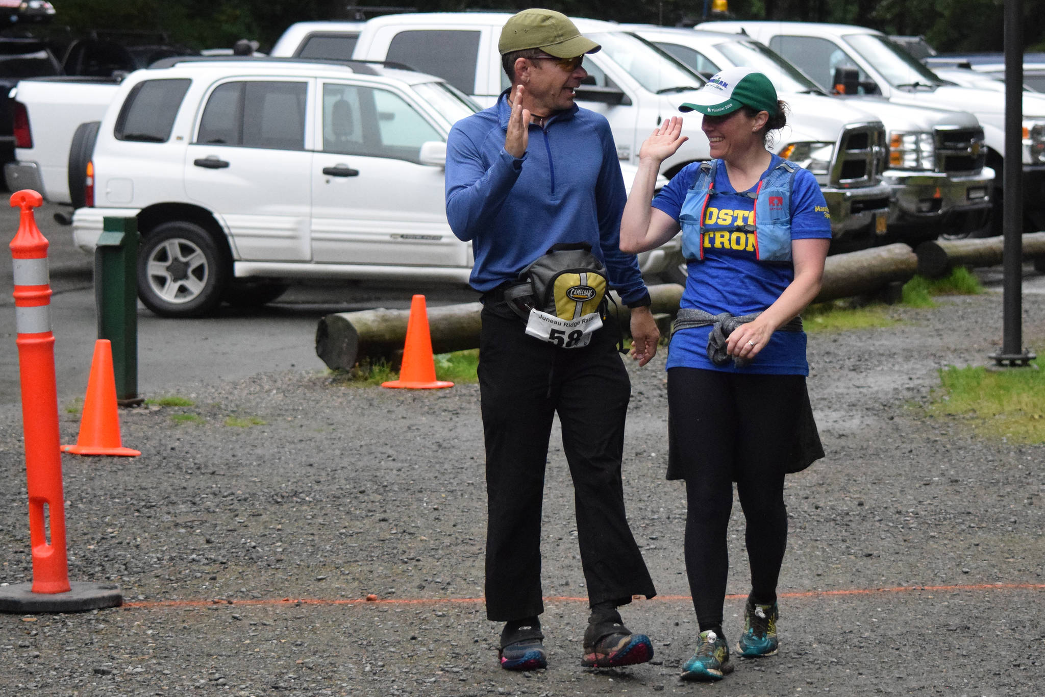 Mike Allen, left, and Kimberly Campbell congratulate one another after crossing the finish line of the Juneau Ridge Race at Cope Park on Saturday, July 20, 2019. Over 60 runners participated in the 15-mile mountain running race that featured approximately 5,000 feet of elevation gain. (Nolin Ainsworth | Juneau Empire)
