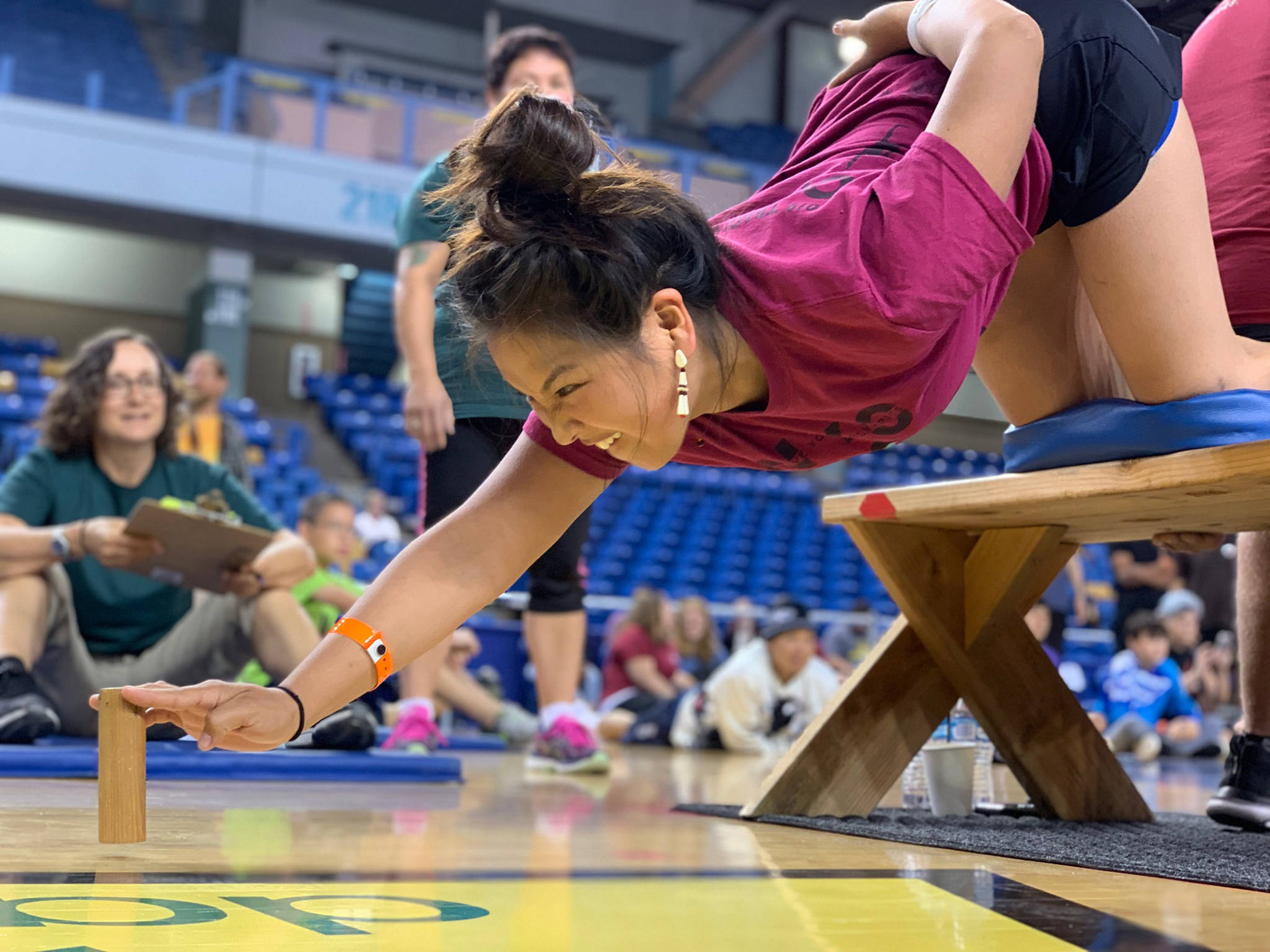 Coach Kaytlynne Lewis competes in the bench reach at the World-Eskimo Indian Olympics at the Carlson Center in Fairbanks on Saturday, July 20, 2019. (Greg Lincoln | For the Juneau Empire)