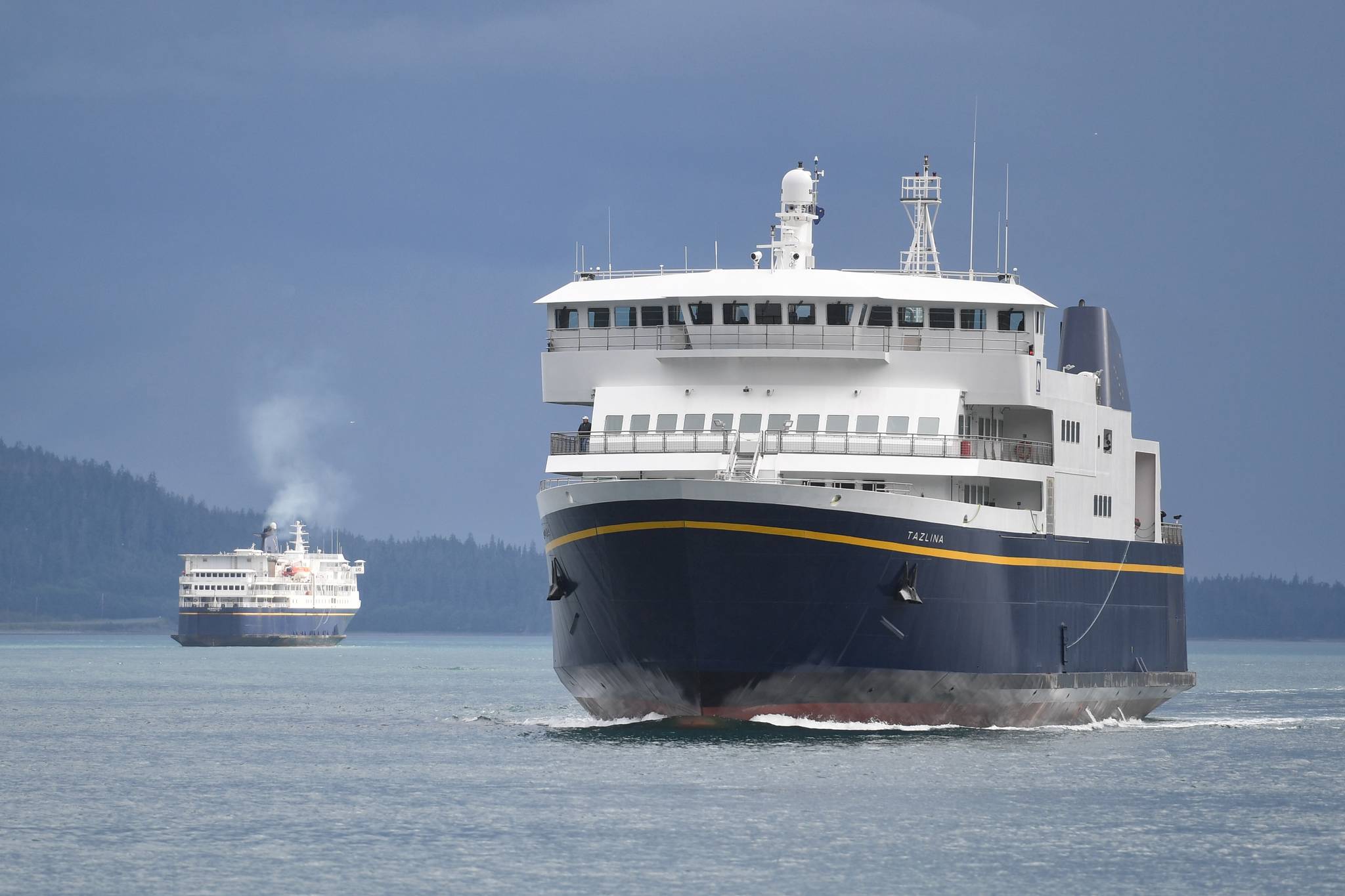 The Alaska Marine Highway System’s Tazlina, right, arrives at the Auke Bay Terminal as the Kennicott departs on Wednesday, July 24, 2019. (Michael Penn | Juneau Empire)