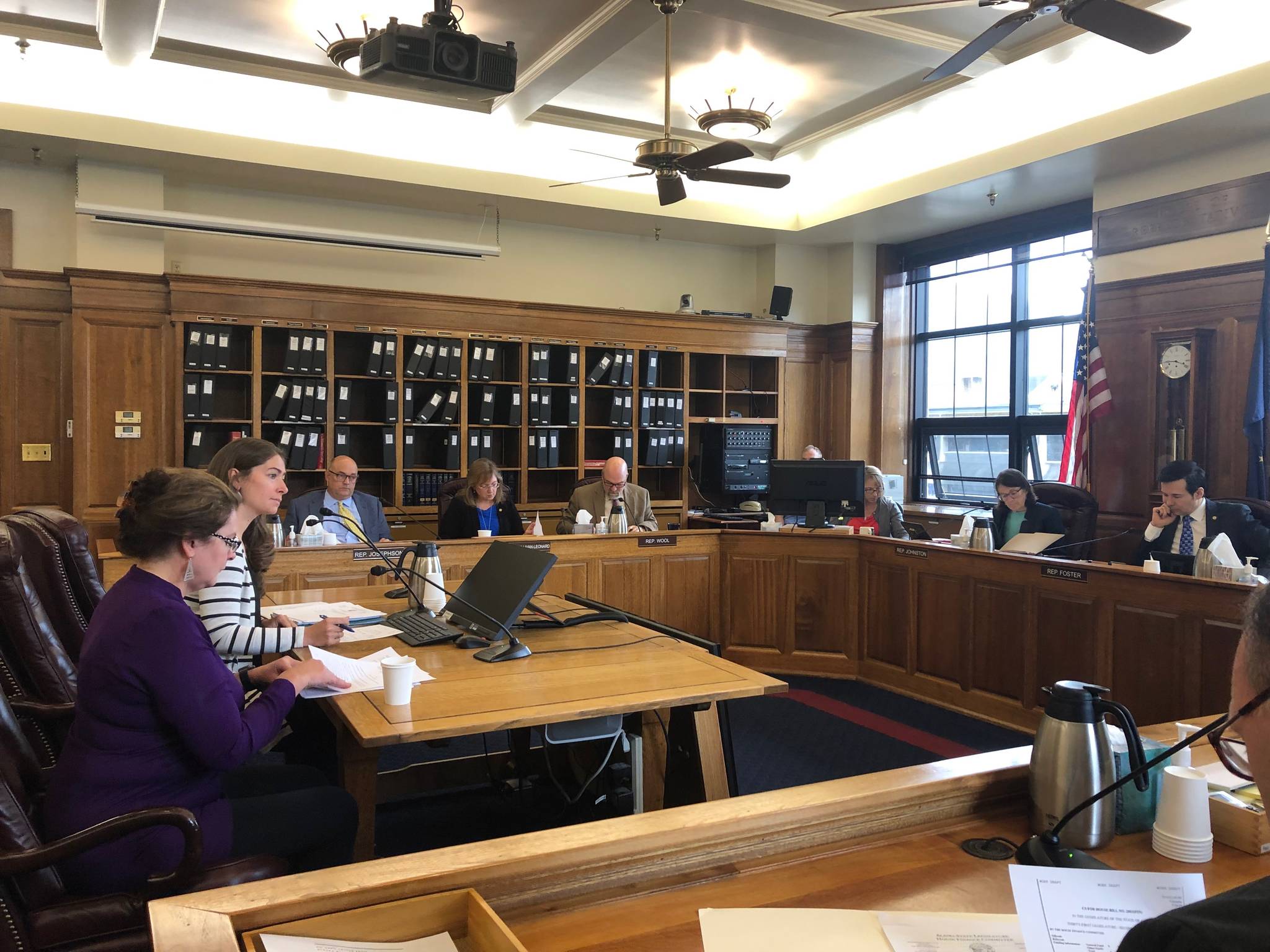 Erin Shine, in white, from Rep. Jennifer Johnston’s staff, and Amanda Ryder, in blue, from the Legislative Finance Division give testimony to the House Finance Committee on House Bill 2003 on Thursday, July 25, 2019. (Peter Segall | Juneau Empire)