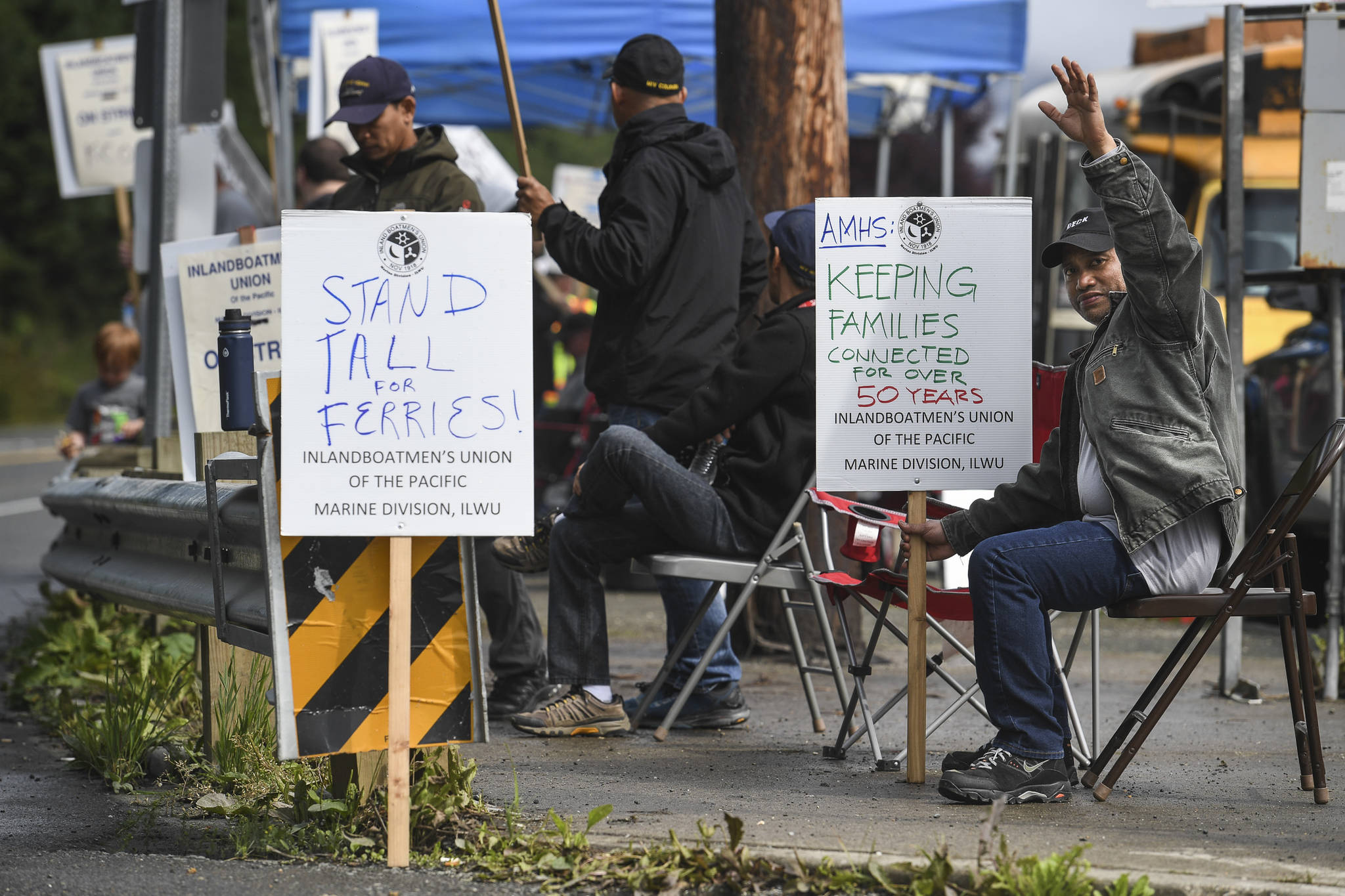 Neil Calberon, right, mans the picket line with others on the third day of the Inland Boatmen’s Union of the Pacific’s strike against the Alaska Marine Highway System at the Auke Bay Terminal on Friday, July 26, 2019. (Michael Penn | Juneau Empire)