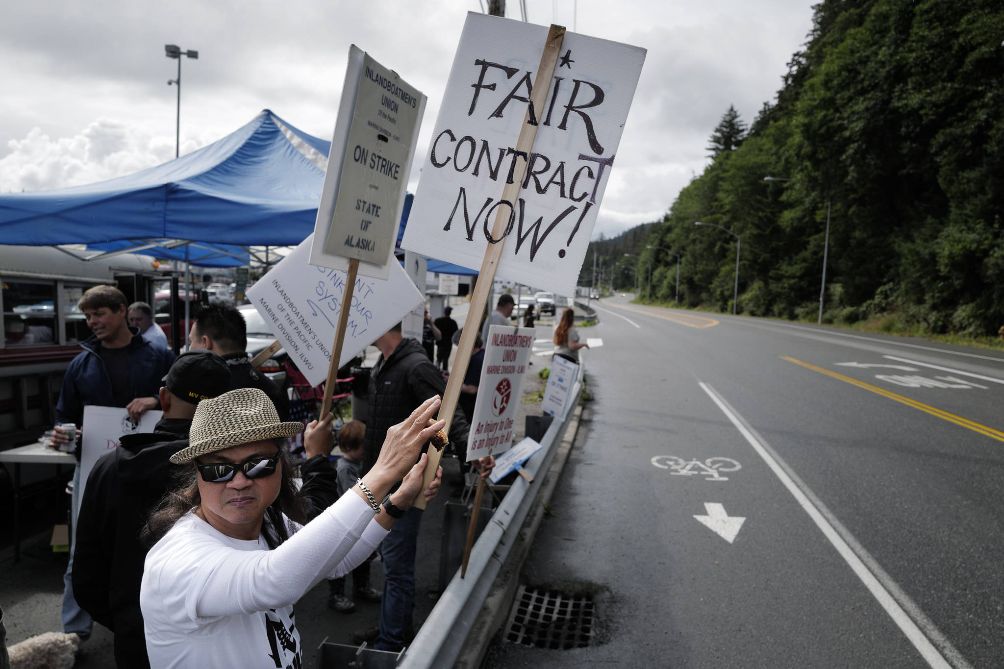 Roland Lumbab mans the picket line with others on the third day of the Inland Boatmen’s Union of the Pacific’s strike against the Alaska Marine Highway System at the Auke Bay Terminal on Friday, July 26, 2019. (Michael Penn | Juneau Empire)