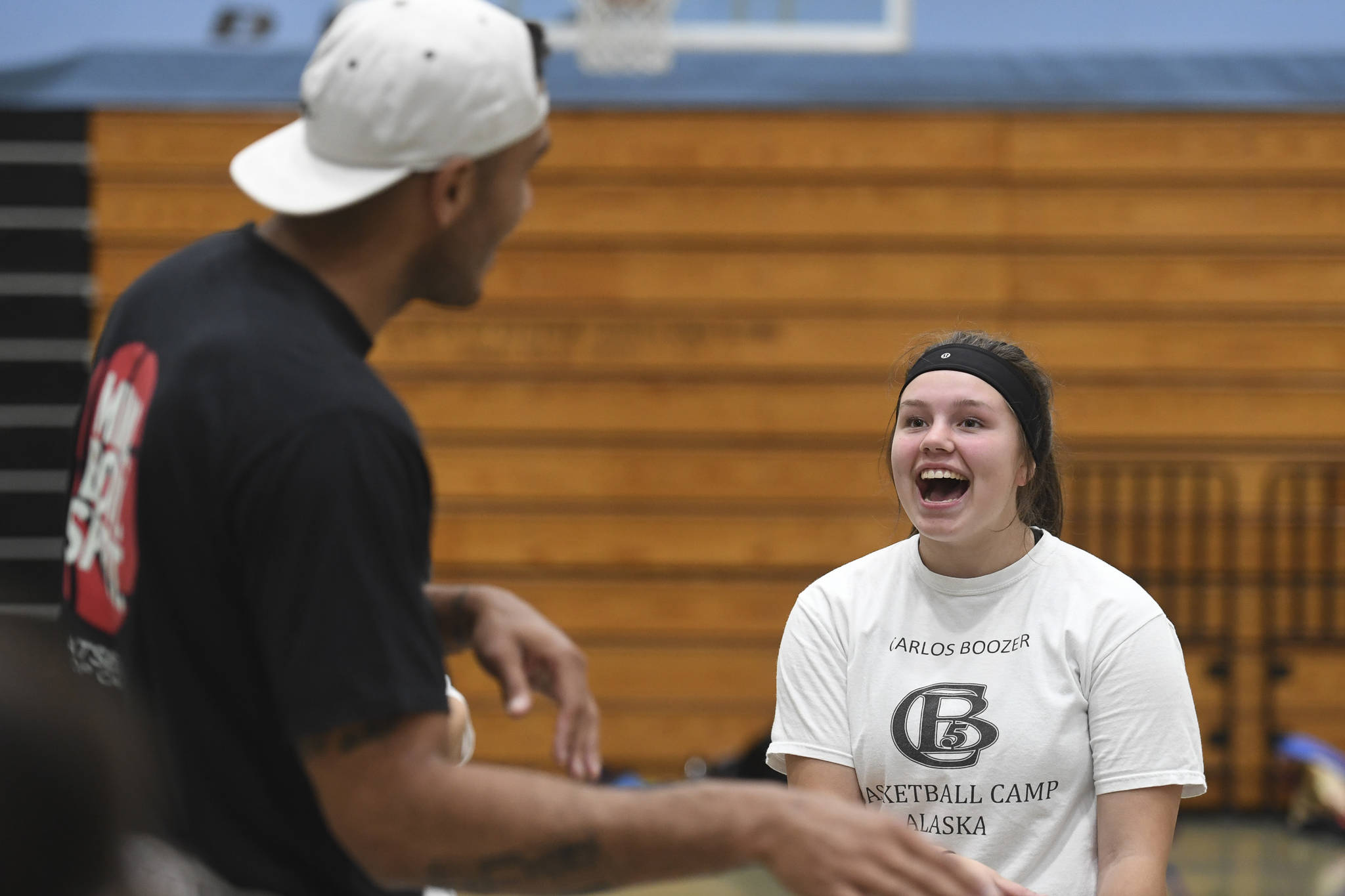 Student Kaia Smith, 15, practices her Haida language with former professional basketball player Damen Bell-Holter during the Latseen Hoop Camp at Dzantak’i Heeni Middle School on Monday, July 29, 2019. The camp runs all week for students entering grades 6-12. (Michael Penn | Juneau Empire)