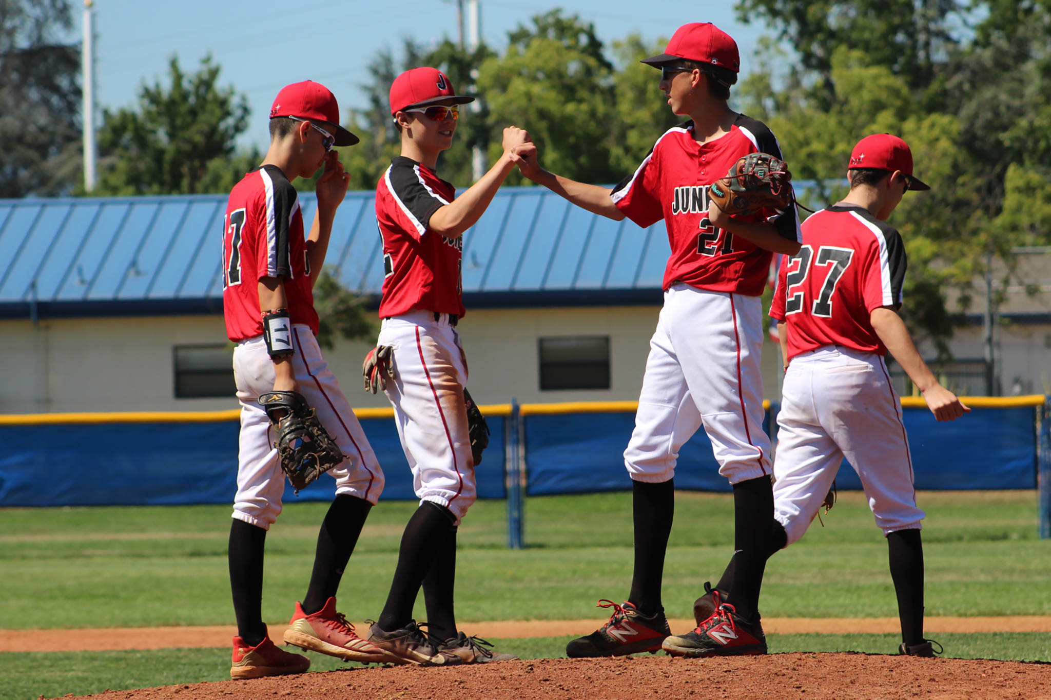 Gastineau Channel Little League Junior All-Star Joe Aline receives encouragement from his teammates in a game against La Grande Little League in the West Regional Tournament at Ida Price Middle School in San Jose, California, on Saturday, July 27, 2019. Juneau lost 10-1. (Courtesy Photo | Lori Crupi)