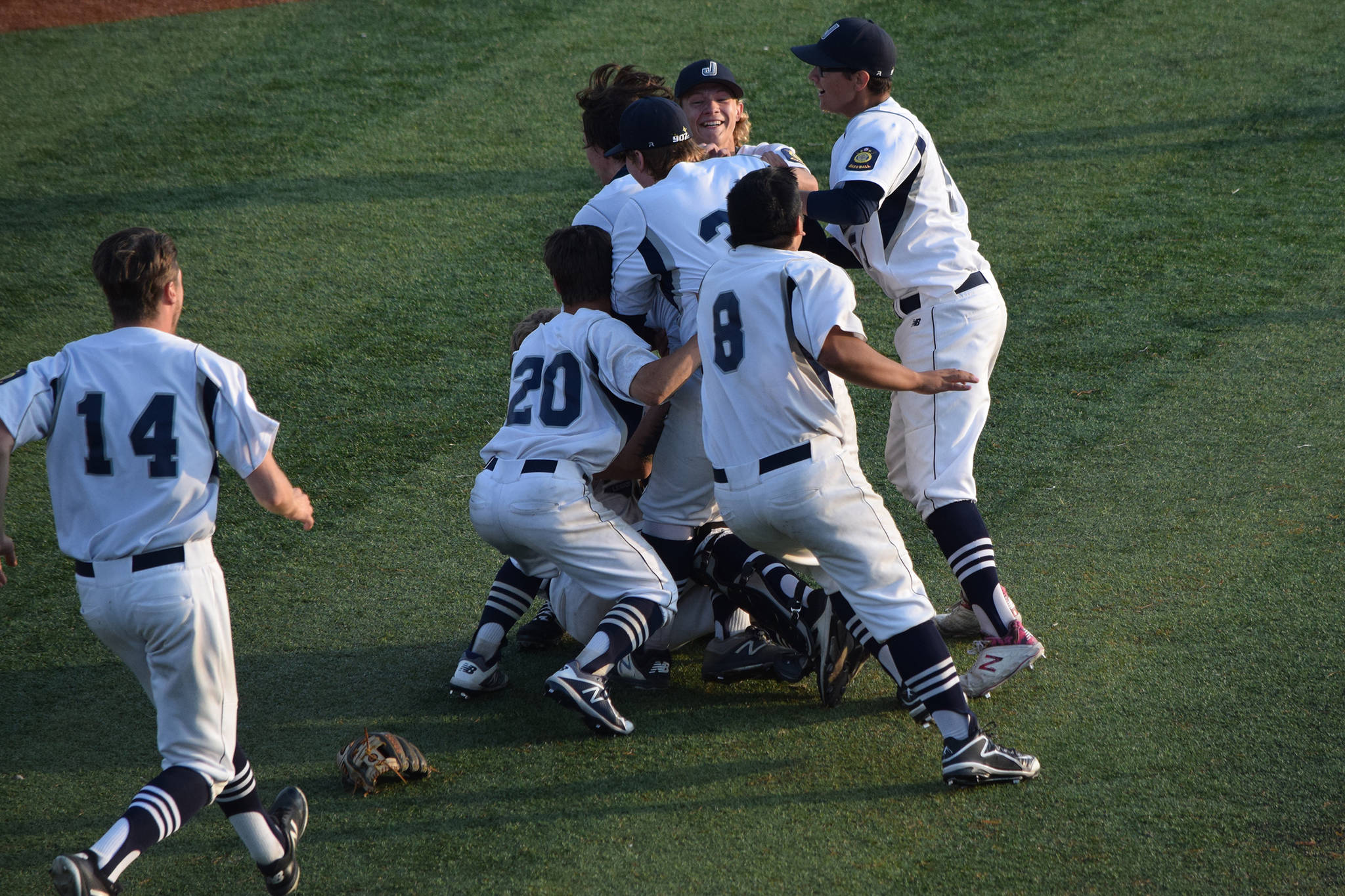 The Juneau Post 25 baseball team celebrates winning its third consecutive American Legion state championship at Mulcahy Stadium in Anchorage on Tuesday, July 30, 2019. Juneau defeated Wasilla Post 35, 13-8, in an eight-inning thriller. (Nolin Ainsworth | Juneau Empire)