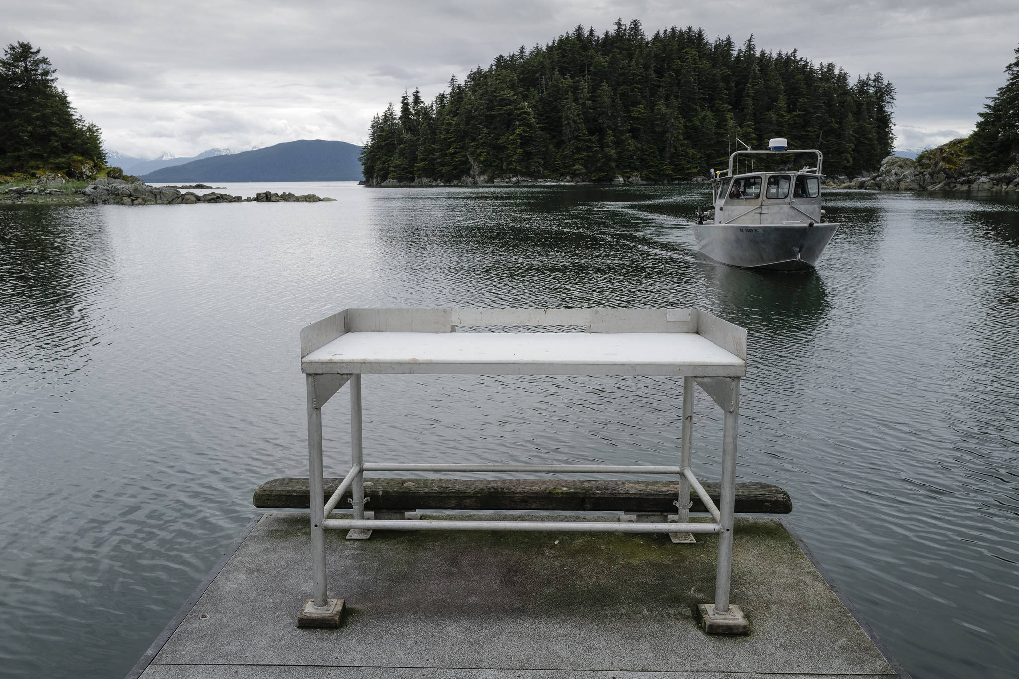 A fisherman approaches the boat launch with its current fish cleaning station at Amalga Harbor on Wednesday, June 19, 2019. (Michael Penn | Juneau Empire)