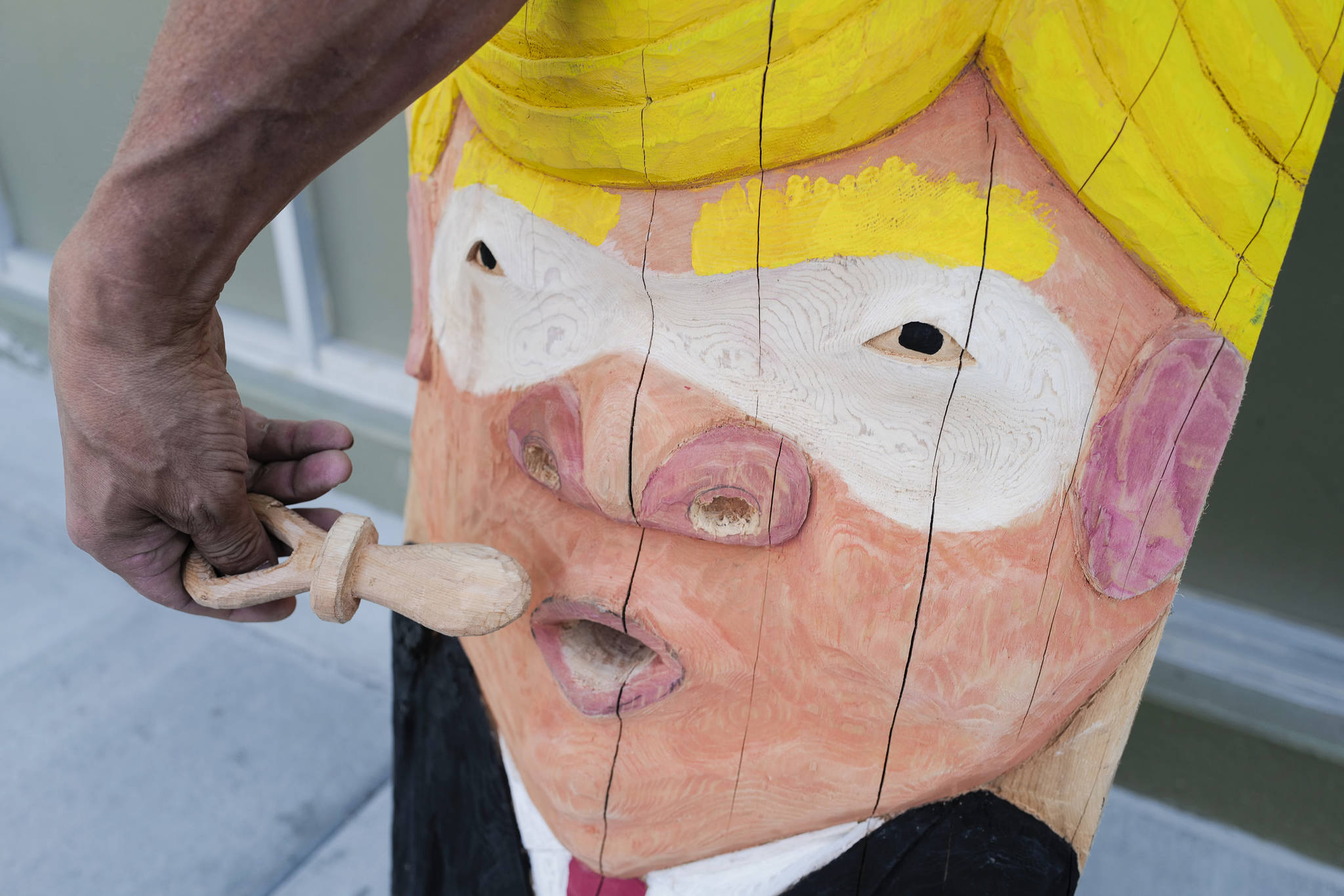 A ridicule pole carved by Sitka artist Tommy Joseph includes a pacifier for the likeness of President Donald Trump. (Michael Penn | Juneau Empire)