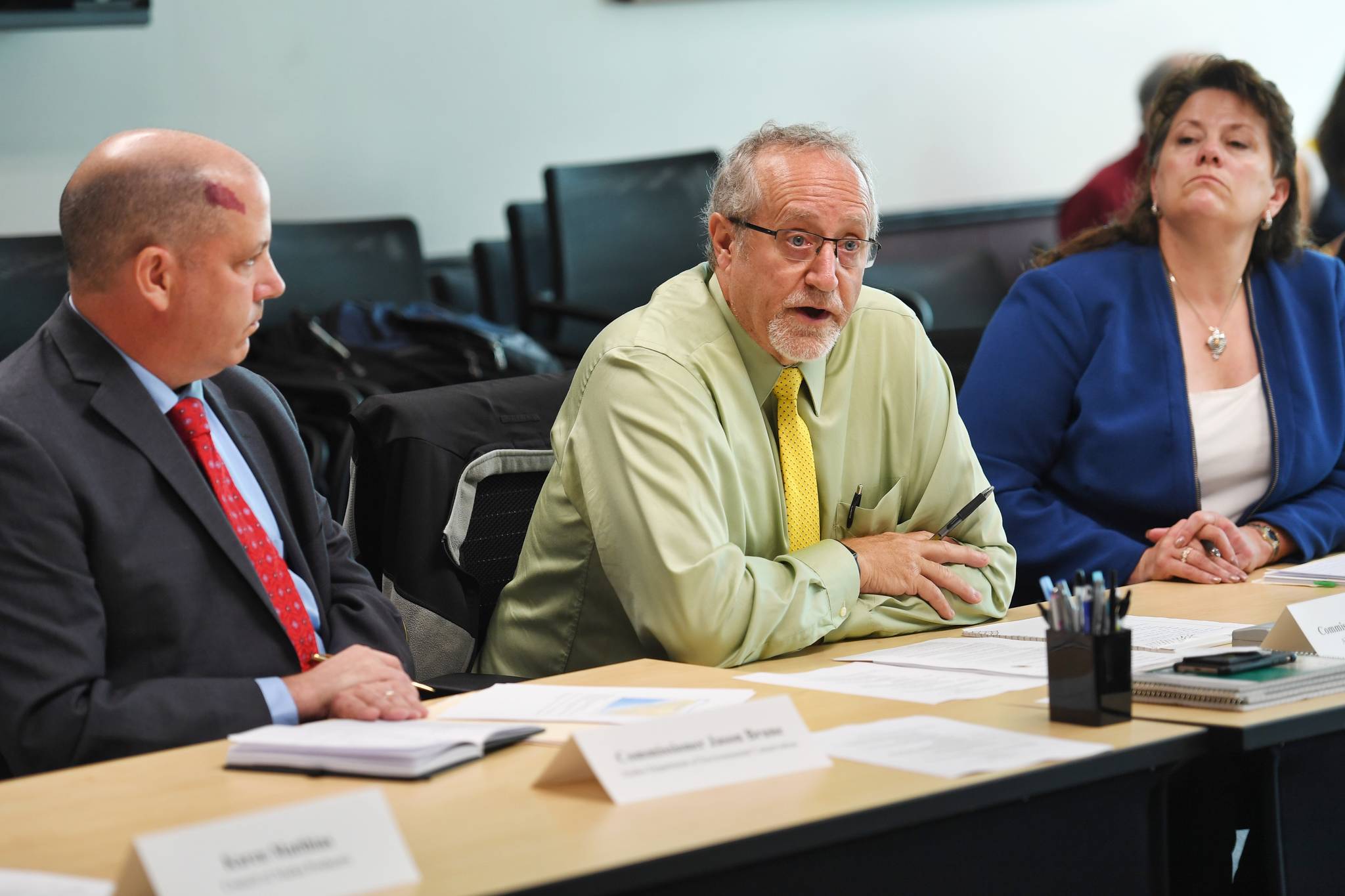 Doug Vincent-Lang, Commissioner of the Alaska Department of Fish and Game, center, speaks during a roundtable meeting on Alaska-British Columbia Transboundary mining at the Federal Building in Juneau on Monday, Aug. 5, 2019. Corri Feige, Commissioner of the Alaska Department of Natural Resources, right, and Jason Brune, Commissioner of the Alaska Department of Environmental Conservation, listen. (Michael Penn | Juneau Empire)