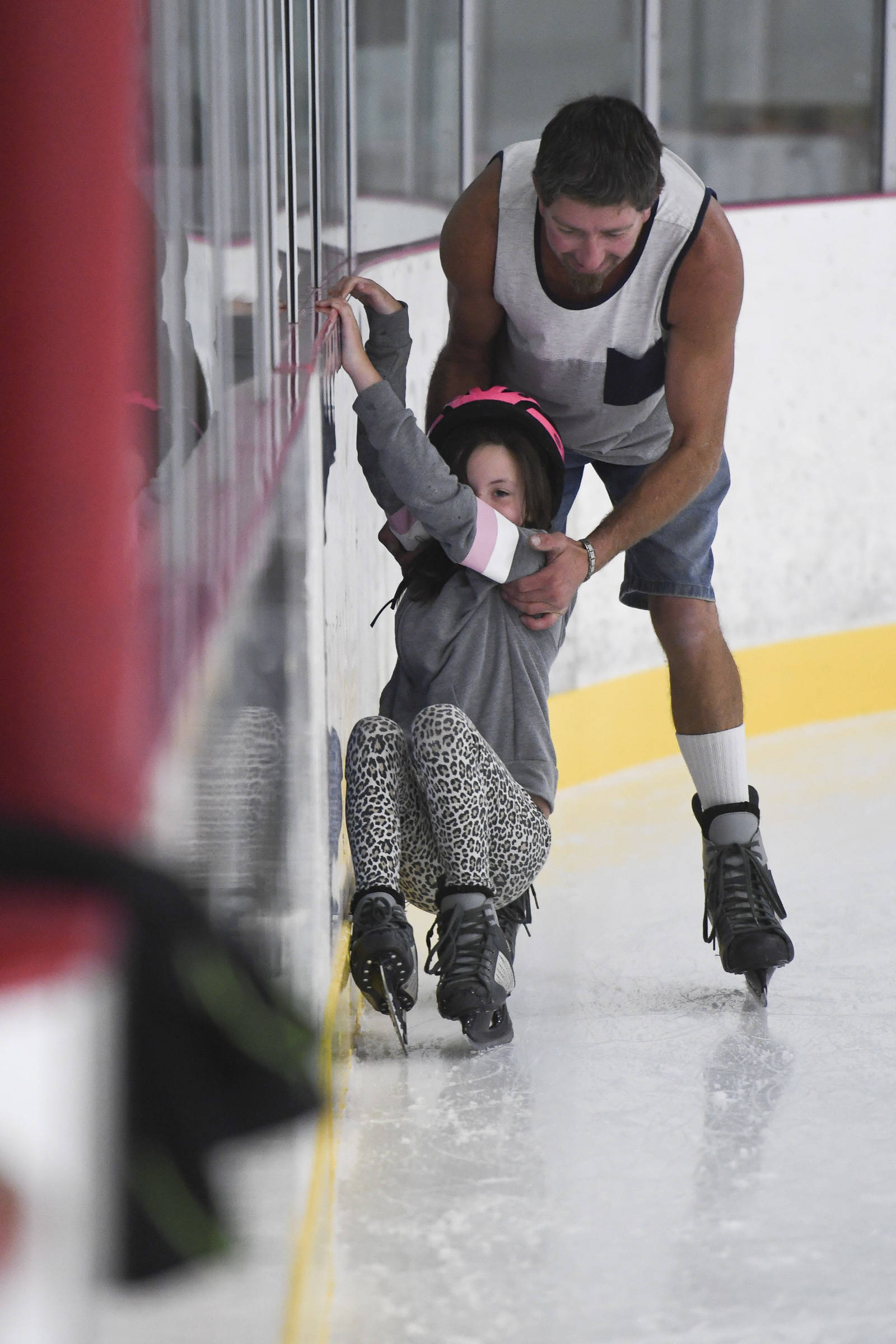 Justin McGeehan helps his daughter, Scarlett learn to skate during a free skate on the opening day at the Treadwell Arena on Monday, Aug. 5, 2019. (Michael Penn | Juneau Empire)