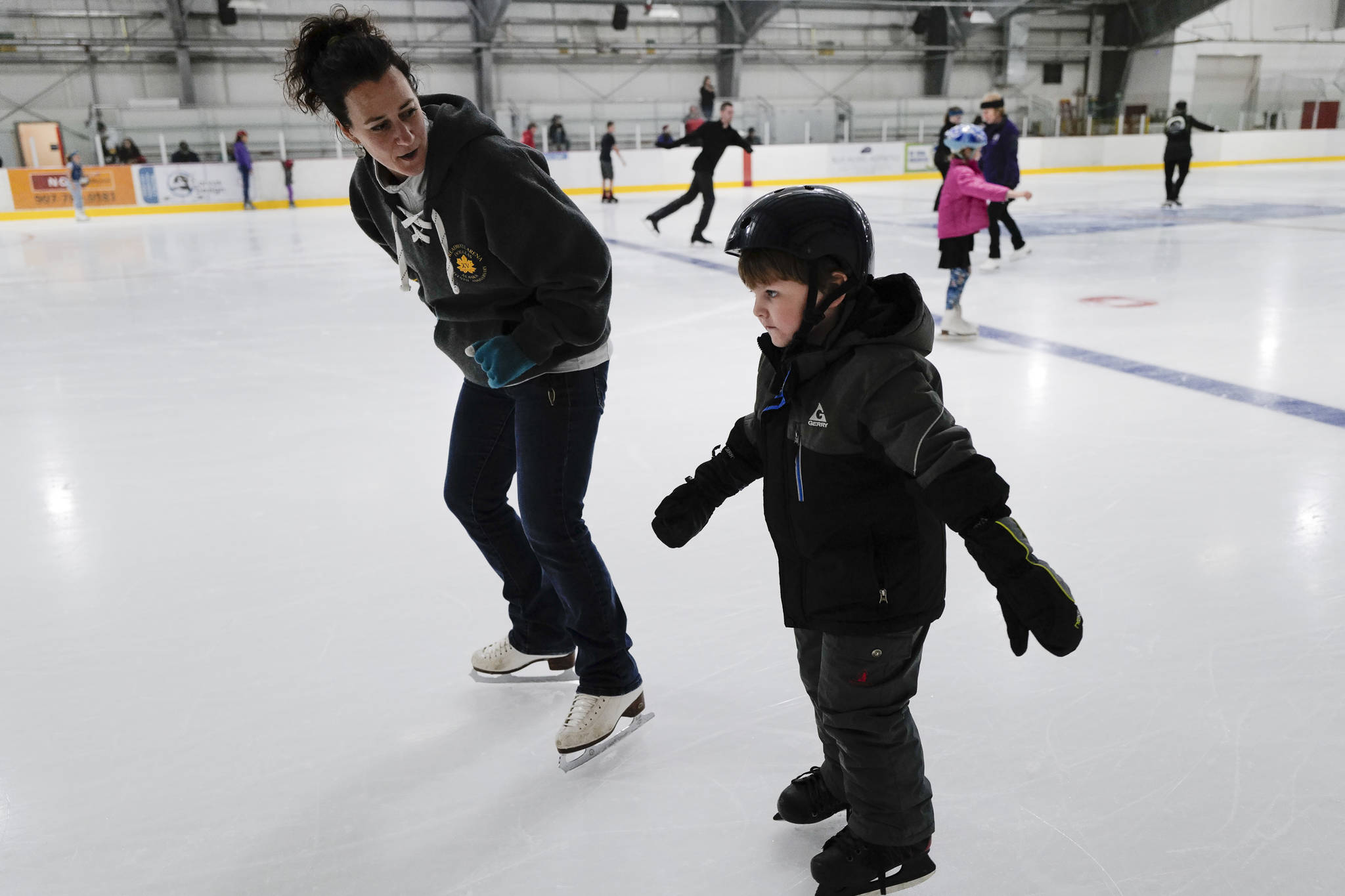 Treadwell Arena Manager Lauren Anderson gives encouragement to Victor DeBartolo, 4, during a free skate on the opening day at the Treadwell Arena on Monday, Aug. 5, 2019. (Michael Penn | Juneau Empire)