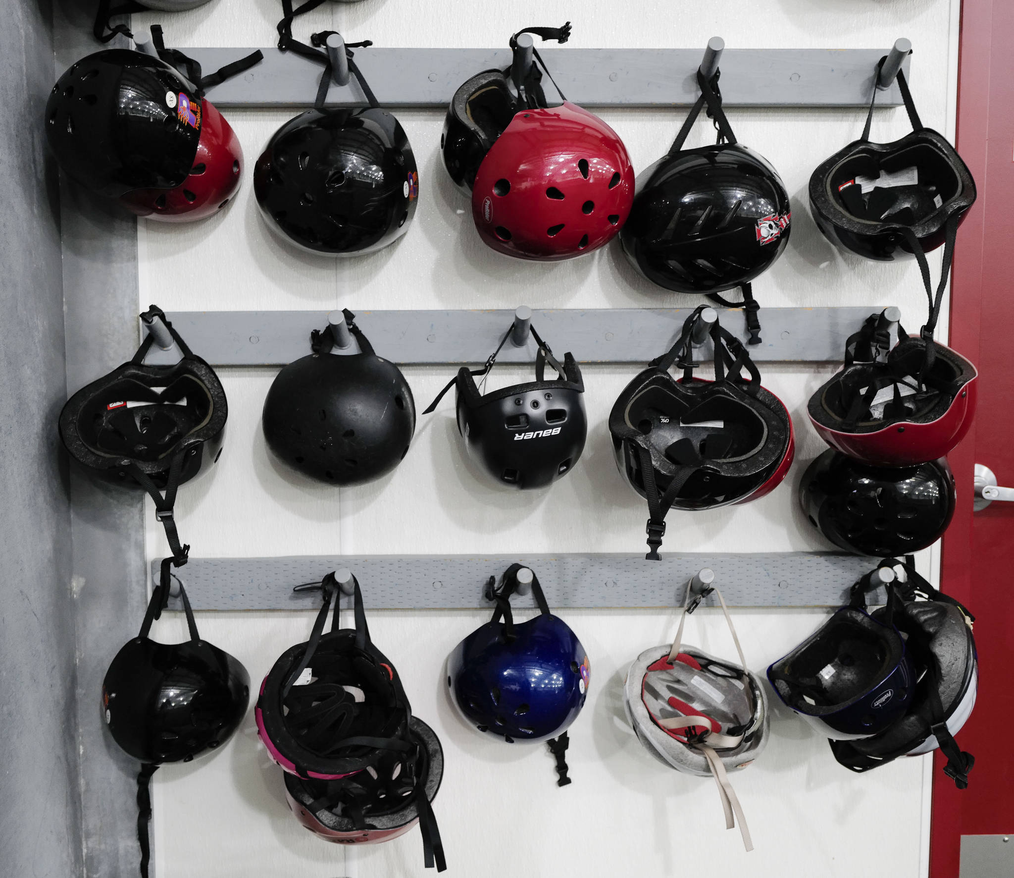 Helmets of all sizes wait for Juneau skaters and families to take advantage of a free skate on the opening day at the Treadwell Arena on Monday, Aug. 5, 2019. (Michael Penn | Juneau Empire)