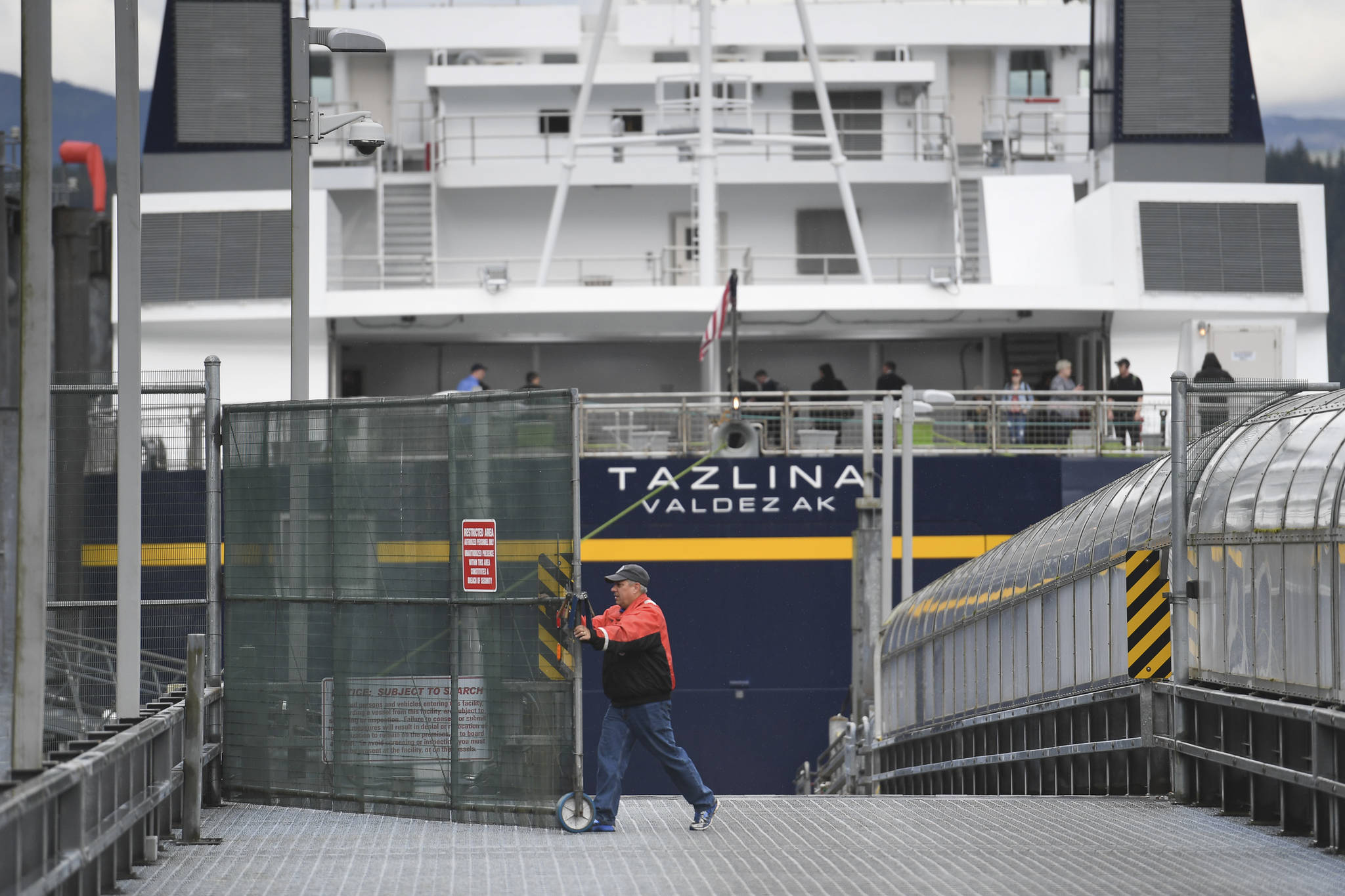 The Alaska Marine Highway System employee opens the vehicle gate after the Tazlina arrives at the Auke Bay Terminal on Wednesday, July 24, 2019. (Michael Penn | Juneau Empire)