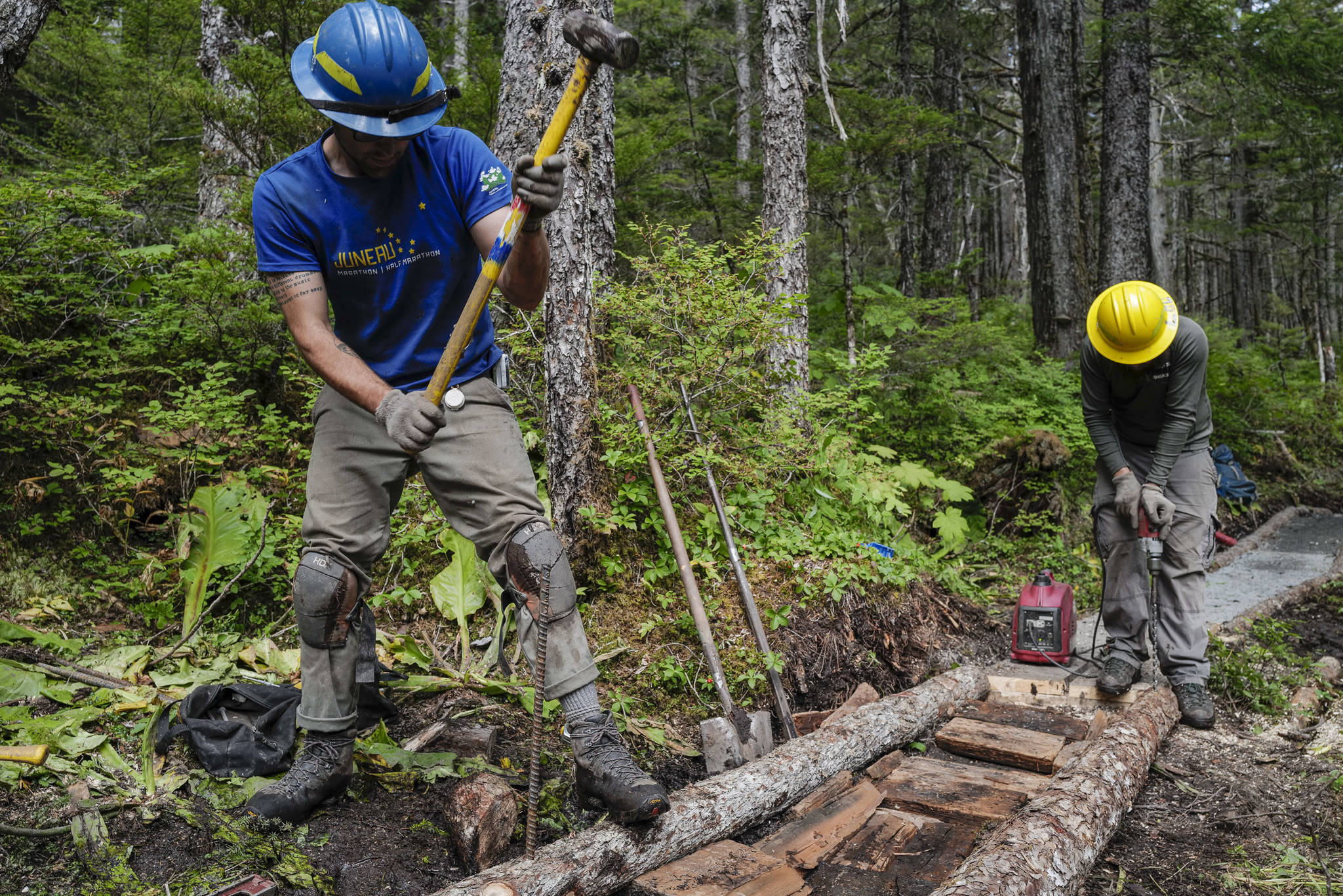 Andres Velez, left, and Lou Eney work on the Auke Nu Trail on the way to the John Muir Cabin on Wednesday, Aug. 7, 2019. (Michael Penn | Juneau Empire)