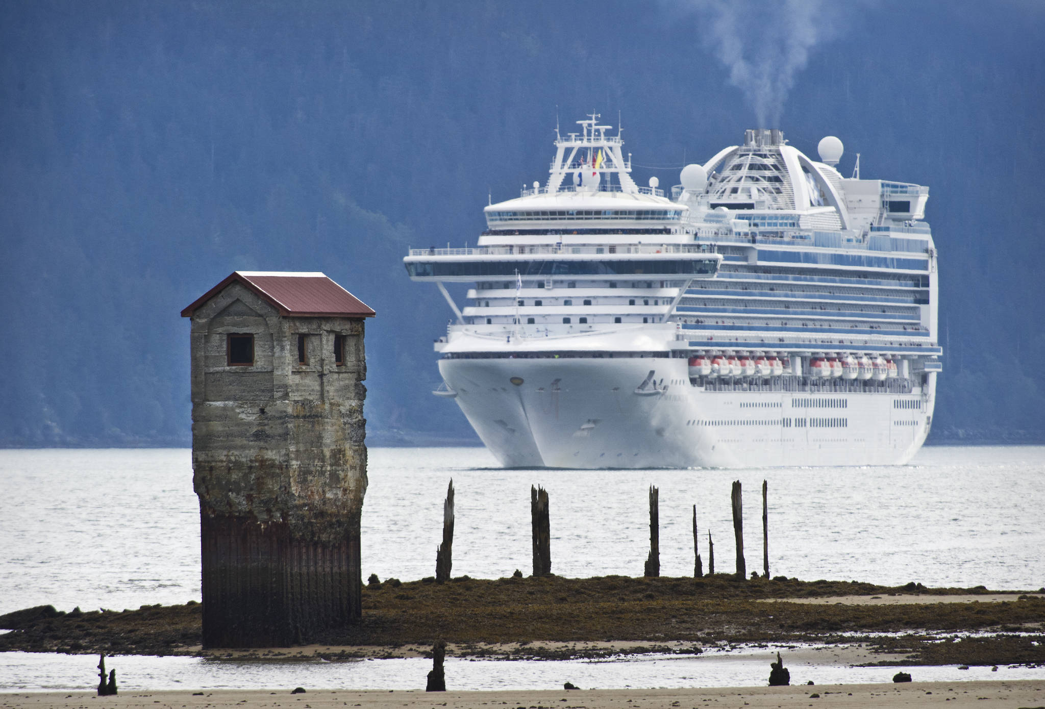 The Crown Princess, owned and operated by Princess Cruises, steams by the ruins of the Treadwell Mine’s salt water Pump House and toward Juneau’s downtown harbor in this September 2015 photo. (Michael Penn | Juneau Empire File)