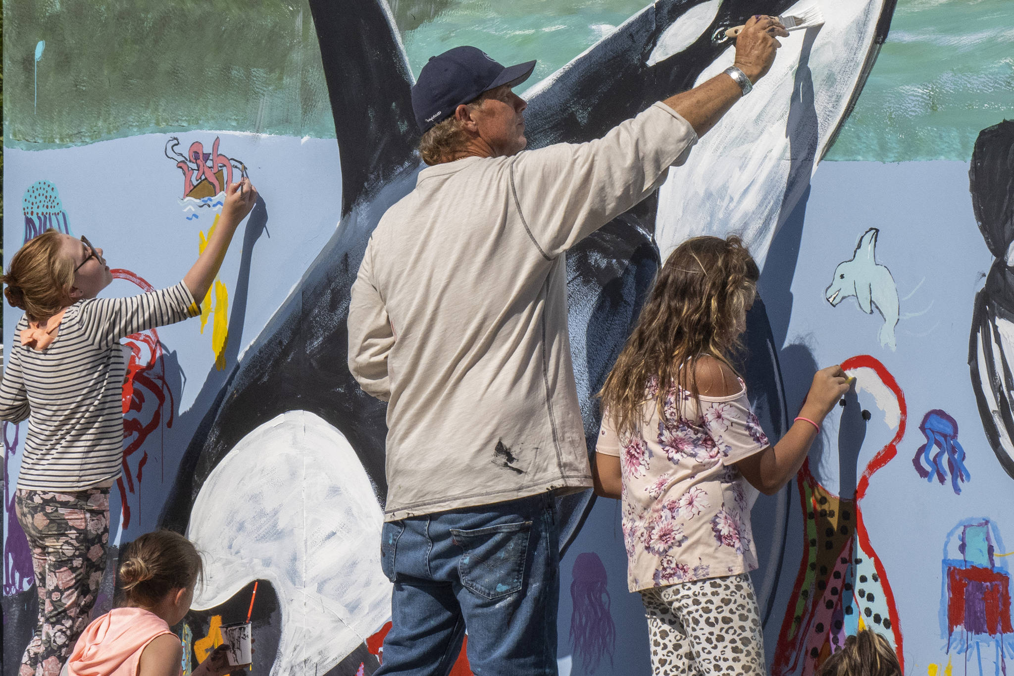 Wyland, a Laguna Beach-based artist, paints a mural with Southeast Alaska children at Icy Strait Point, Saturday, Aug. 10. The visiting artist took inspiration from orcas he saw near Hoonah. (Courtesy Photo | Icy Strait Point)