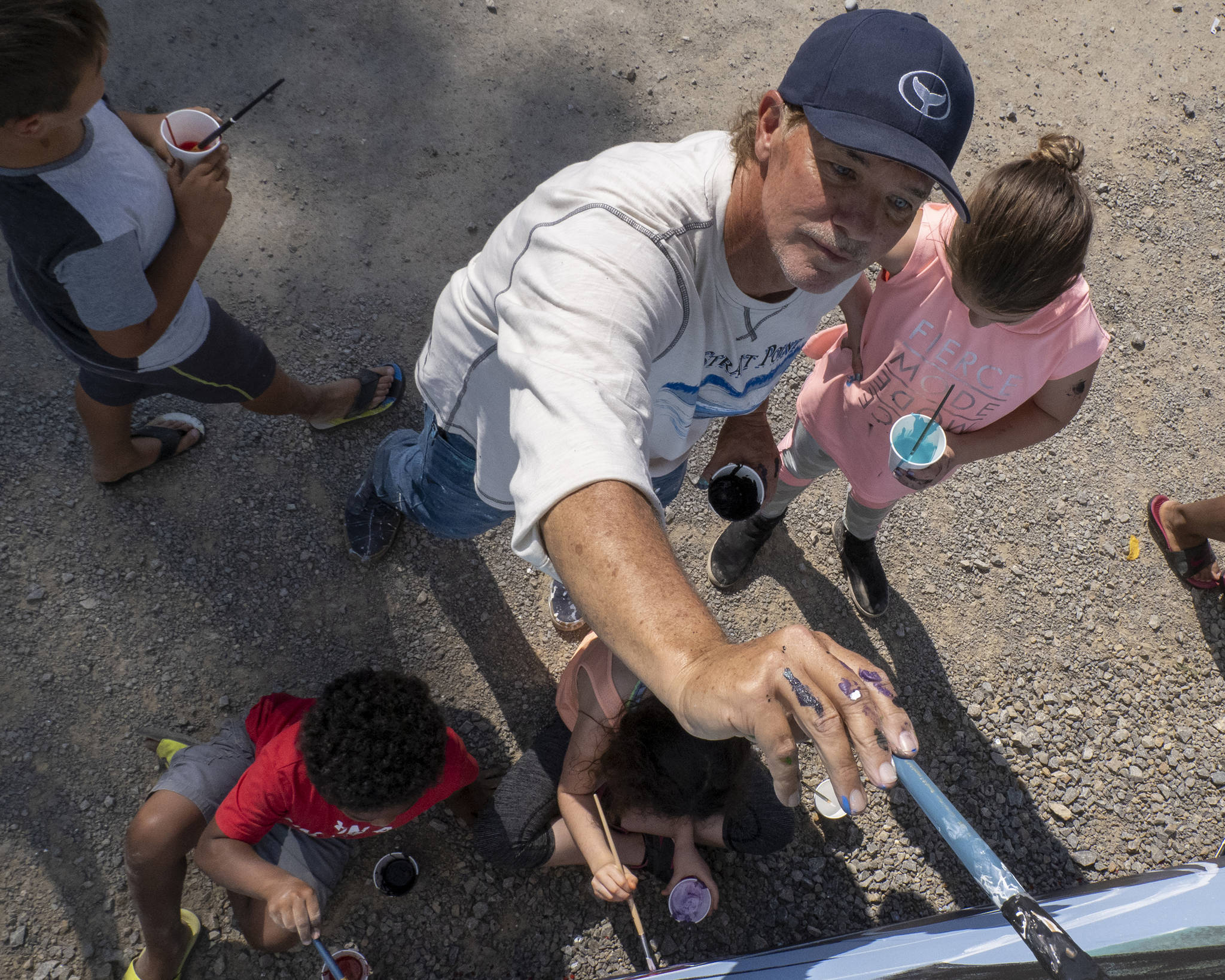 Wyland, a Laguna Beach-based artist, paints a mural with Southeast Alaska children at Icy Strait Point, Saturday, Aug. 10. (Courtesy Photo | Icy Strait Point)