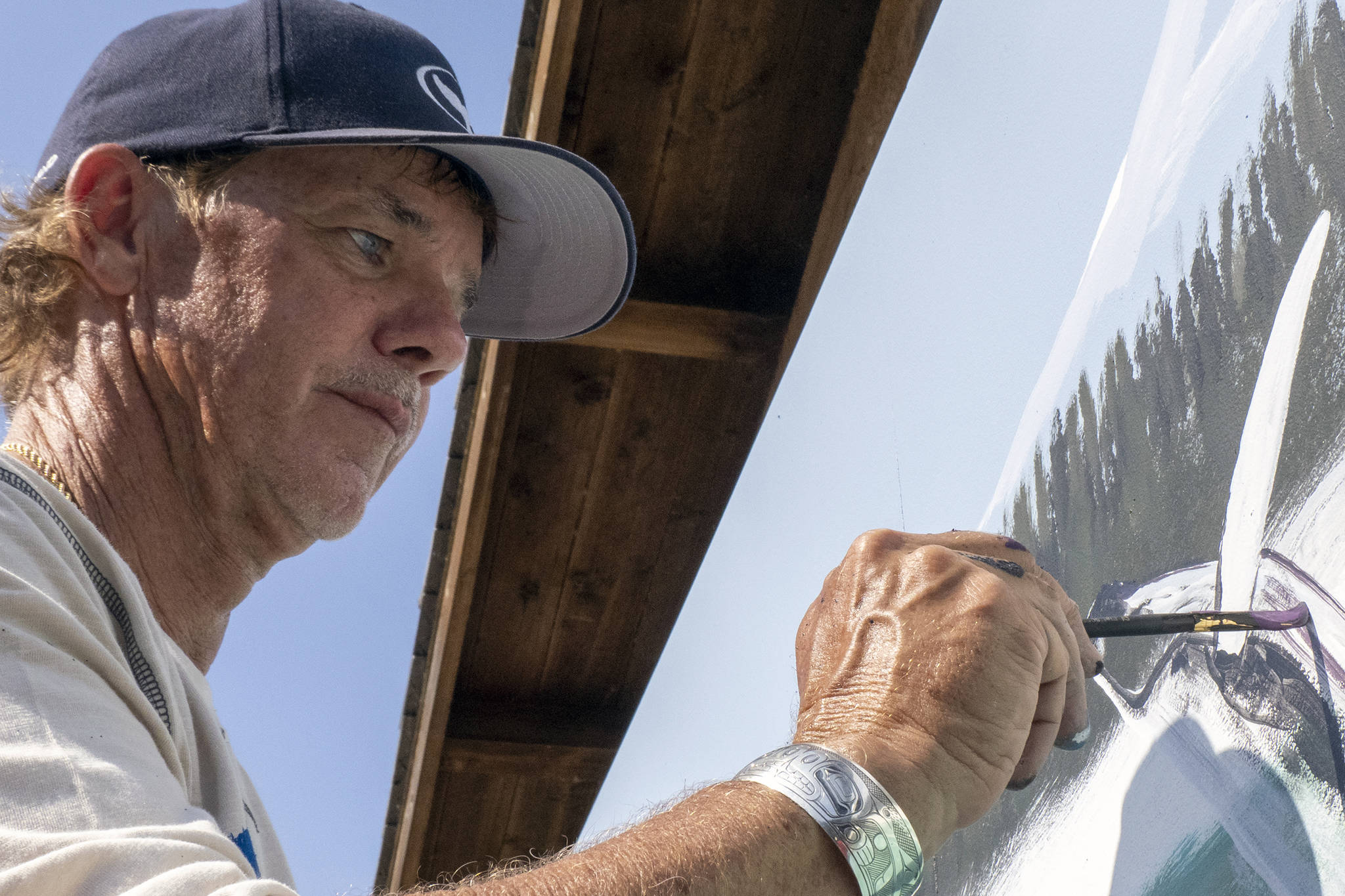 Wyland, an artist based out of Laguna Beach, California, fills in detail while painting a mural at Icy Strait Point, Saturday, Aug. 10. (Courtesy Photo | Icy Strait Point)