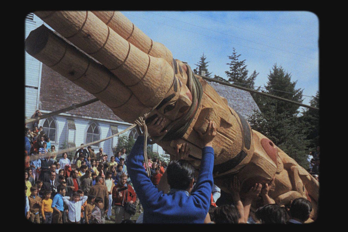 The first totem pole raising in almost a century took place in Old Massett in August 1969. (NFB photo)