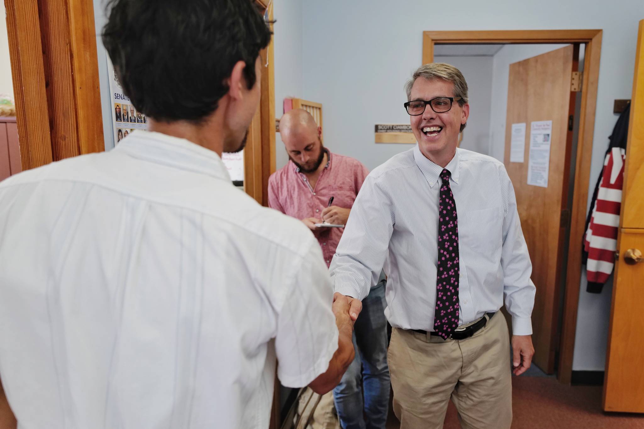 Juneau City Manager Rorie Watt, right, greets Greg Smith after Smith applied to run for one of two Assembly District 1 seats in this falls municipal election on Monday, Aug. 12, 2019. Watt said, “Welcome to the fray.” (Michael Penn | Juneau Empire)