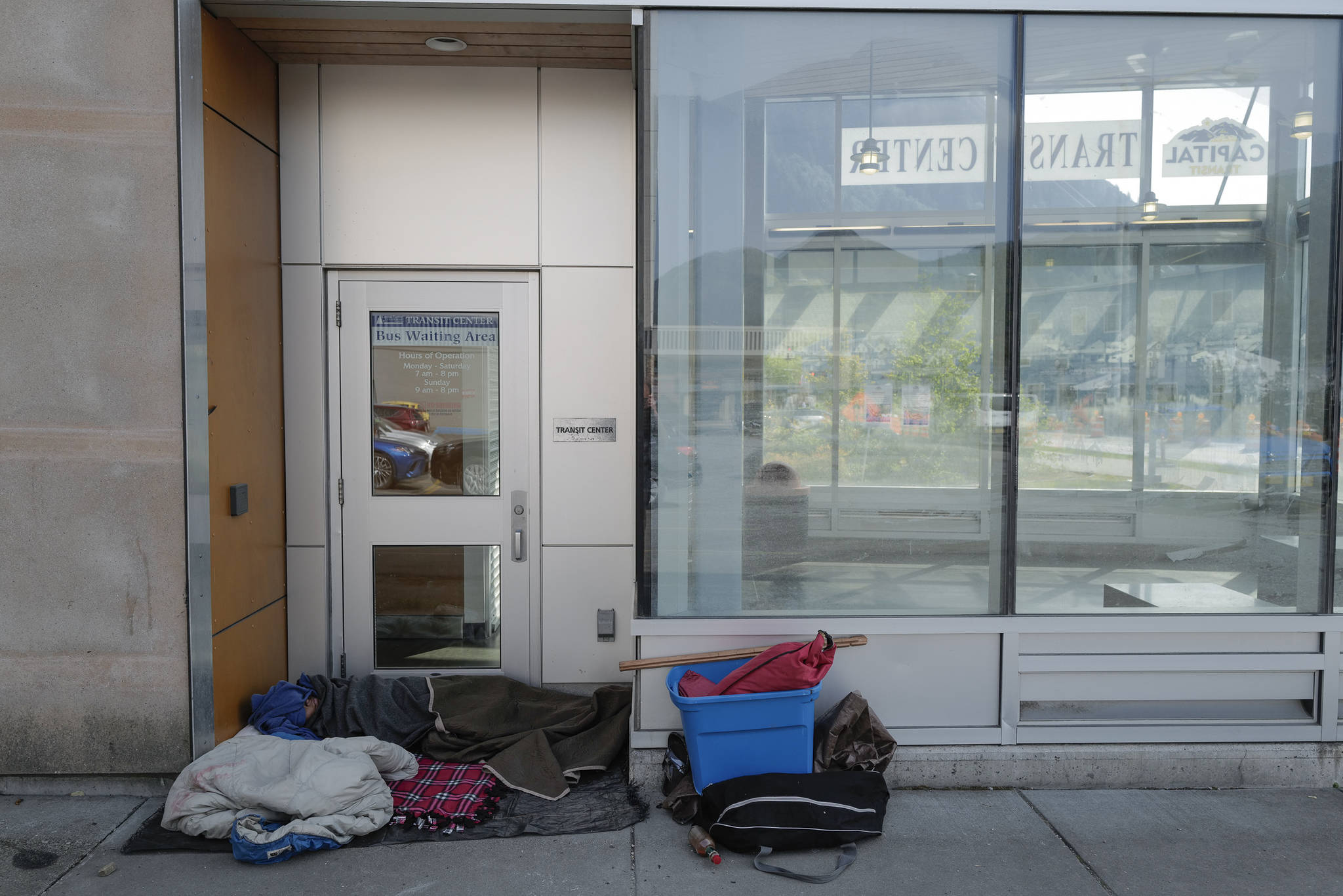 A homeless person sleeps in the doorway at the Capital Transit Center on Tuesday, Aug. 13, 2019. (Michael Penn | Juneau Empire)