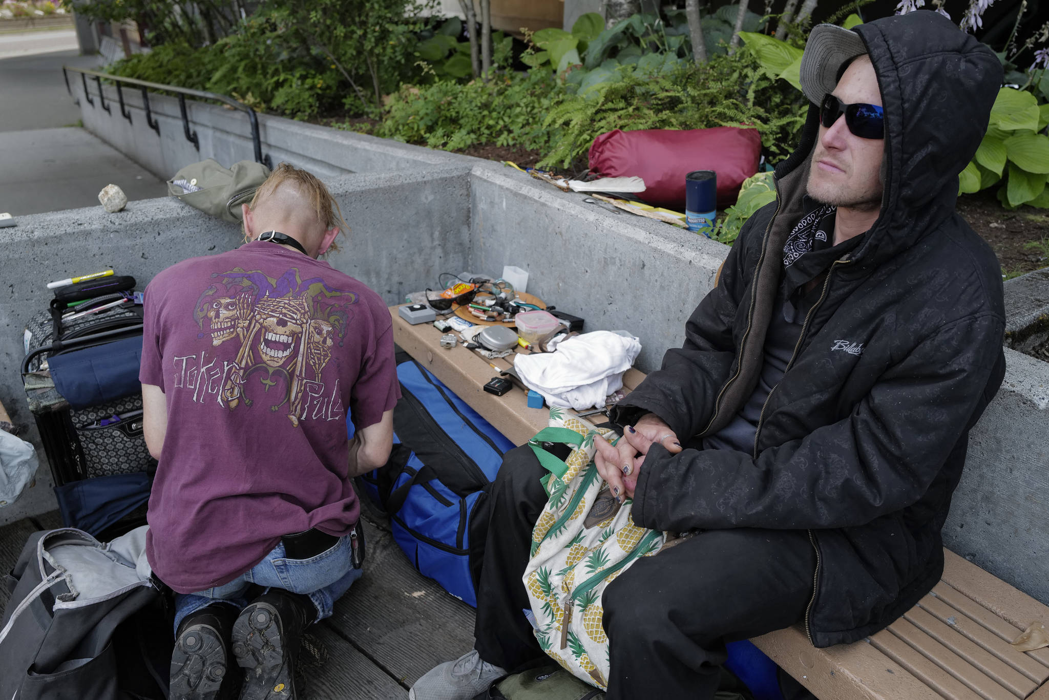 Justin Fairclough, right, and Keoki Cunningham organize their belongings and hang out in front of the Juneau Downtown Library on Tuesday, Aug. 13, 2019. They are currently staying at the Glory Hall at night. (Michael Penn | Juneau Empire)