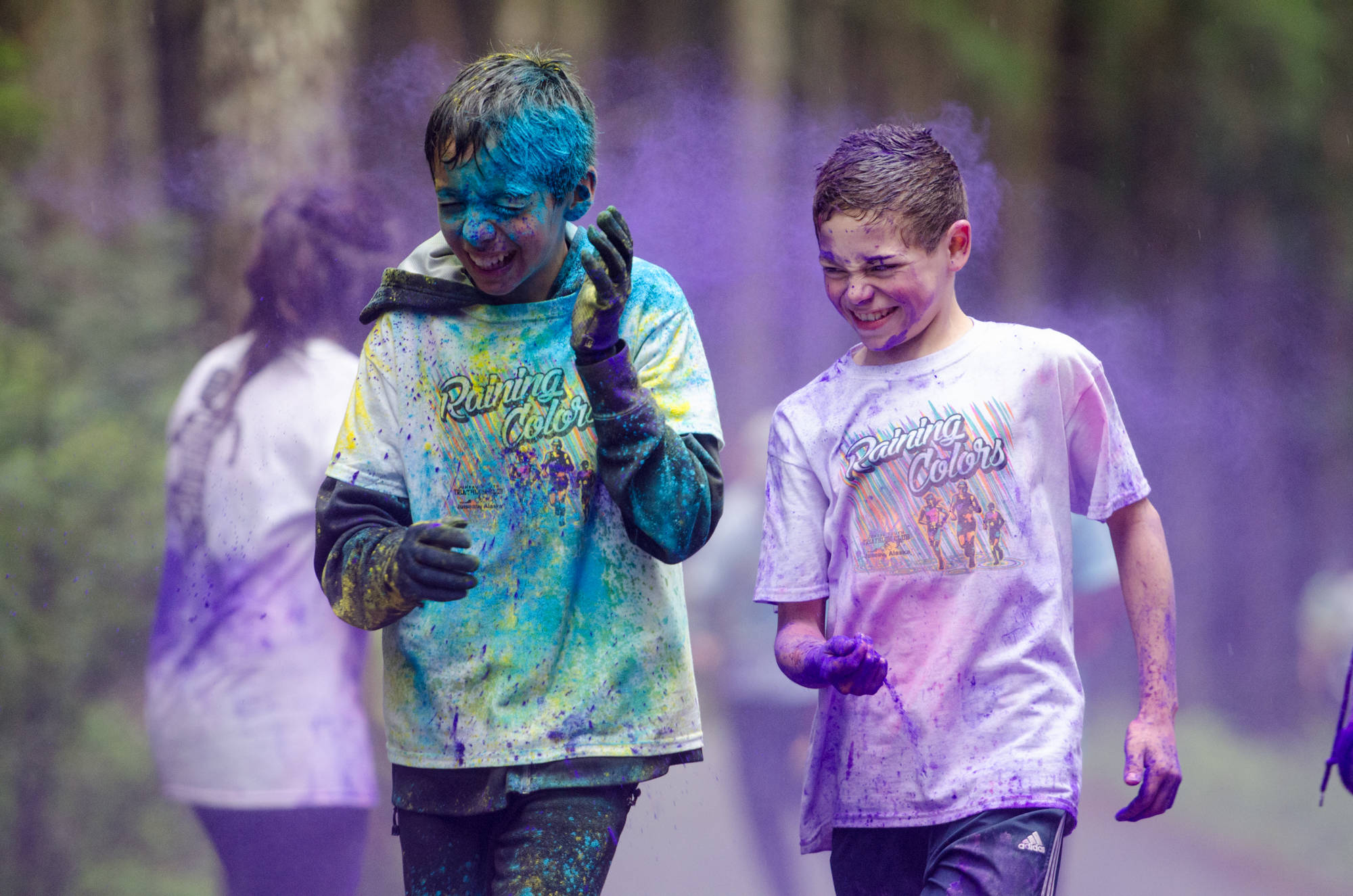 Runners get hit with purple dye during Raining Colors 5K Fun Run in 2016. (Michael Penn | Juneau Empire File)