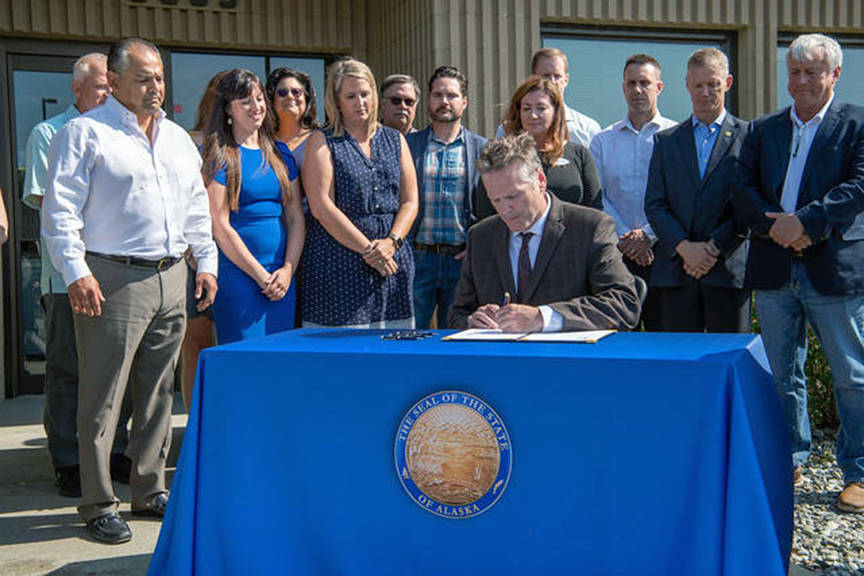Gov. Mike Dunleavy at the signing ceremony for Senate Bill 2002 at the Alaska Association of General Contractors in Anchorage on August 8, 2019. (Courtesy photo)