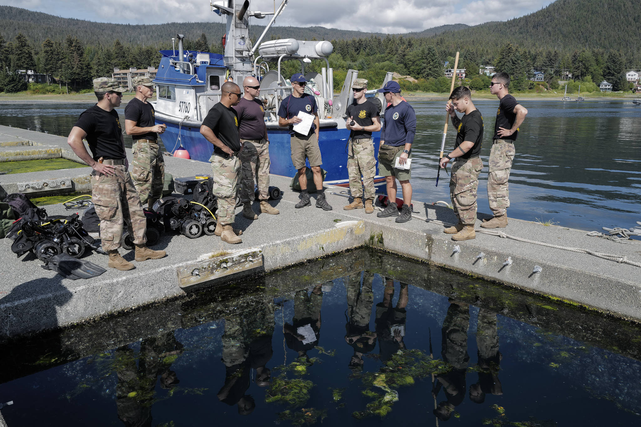Members of the U.S. Army’s 74th Engineer Dive Detachment work with U.S. Coast Guard Regional Dive Locker West members on a project at the Don D. Statter Boat Harbor in Auke Bay on Friday, Aug. 16, 2019. The teams were working together to inspect and replace rusted bolts holding the harbor’s breakwater together. (Michael Penn | Juneau Empire)