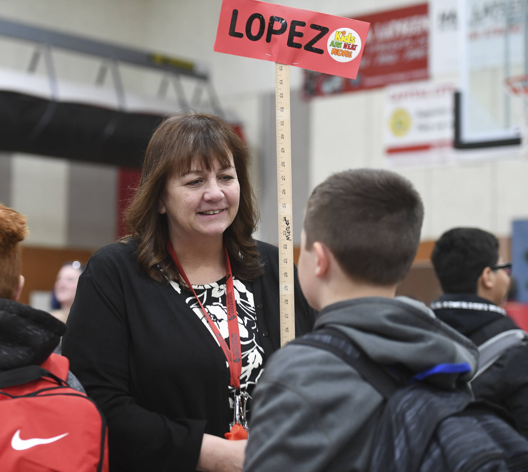 Sixth grade Social Studies Teacher Janet Lopez introduces herself to students arriving for the first day of school at Floyd Dryden Middle School on Monday, Aug. 19, 2019. (Michael Penn | Juneau Empire)