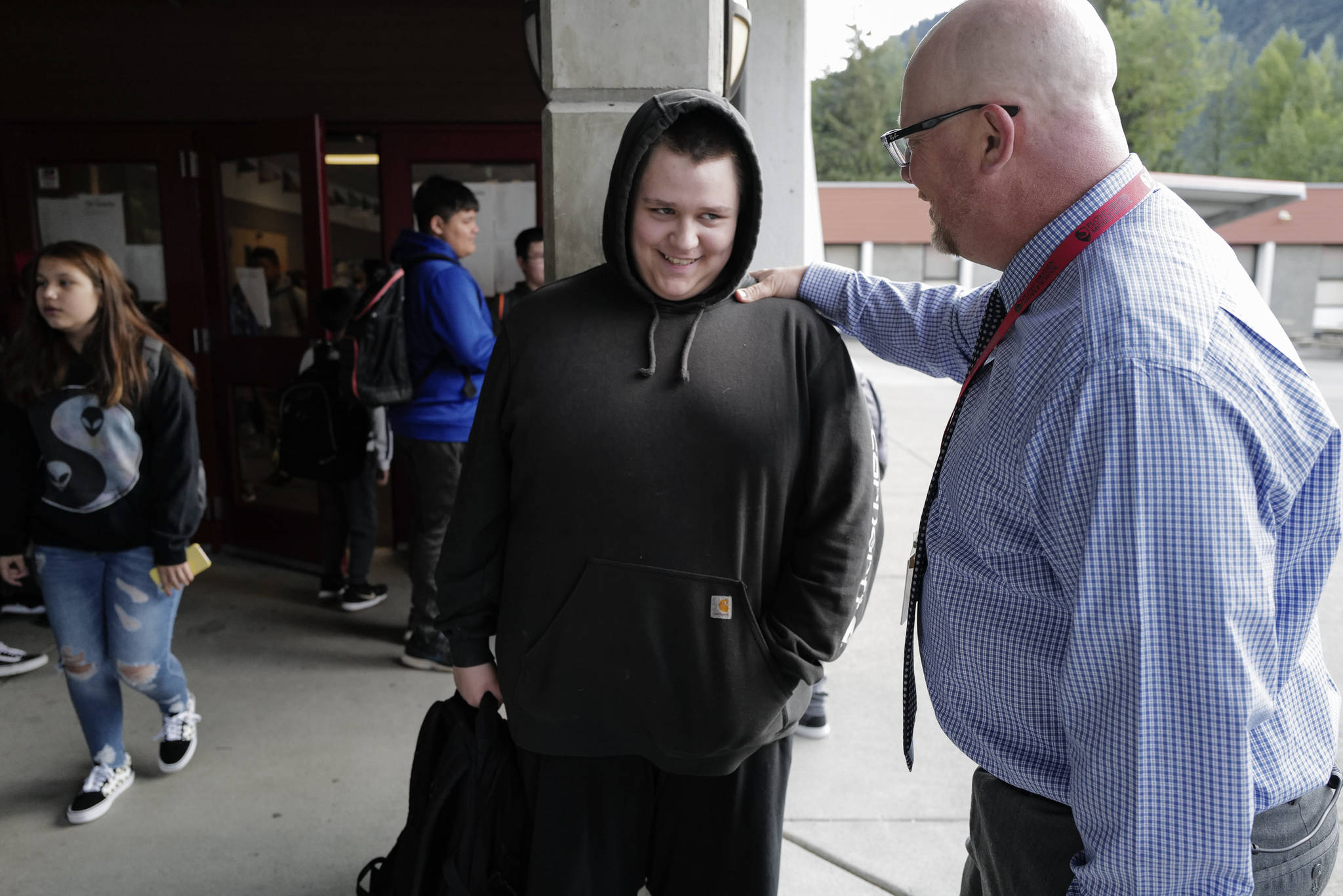 Principal Jim Thompson greets eight-grader Dalton Bell on the first day of school at Floyd Dryden Middle School on Monday, Aug. 19, 2019. (Michael Penn | Juneau Empire)