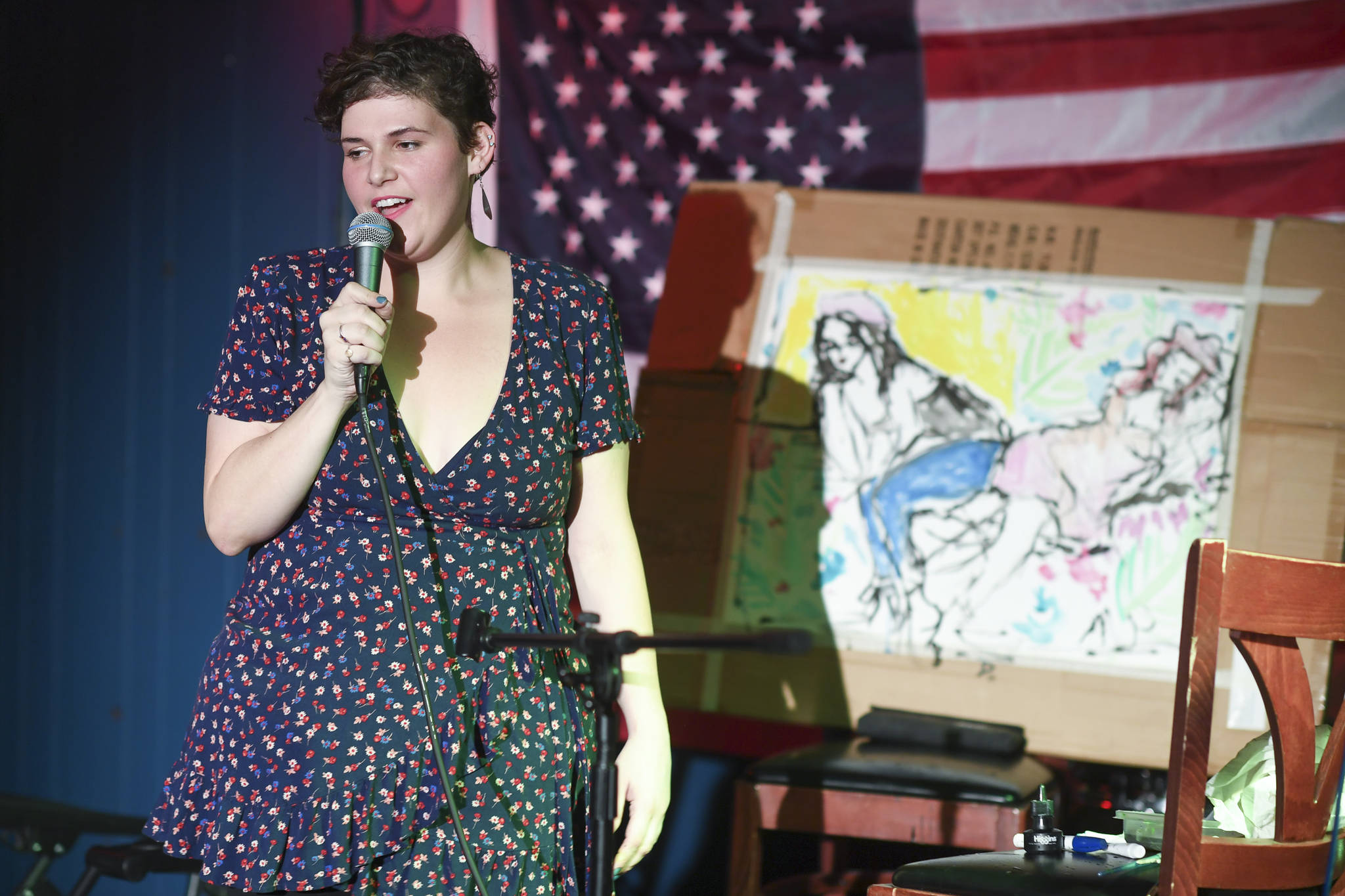 Natalie Weinberg performs with a live model painting of Dana Herndon and Serena Drazkowski during the GRLZ open mic night at the The Rendezvous Bar on Wednesday, Aug. 14, 2019. (Michael Penn | Juneau Empire)