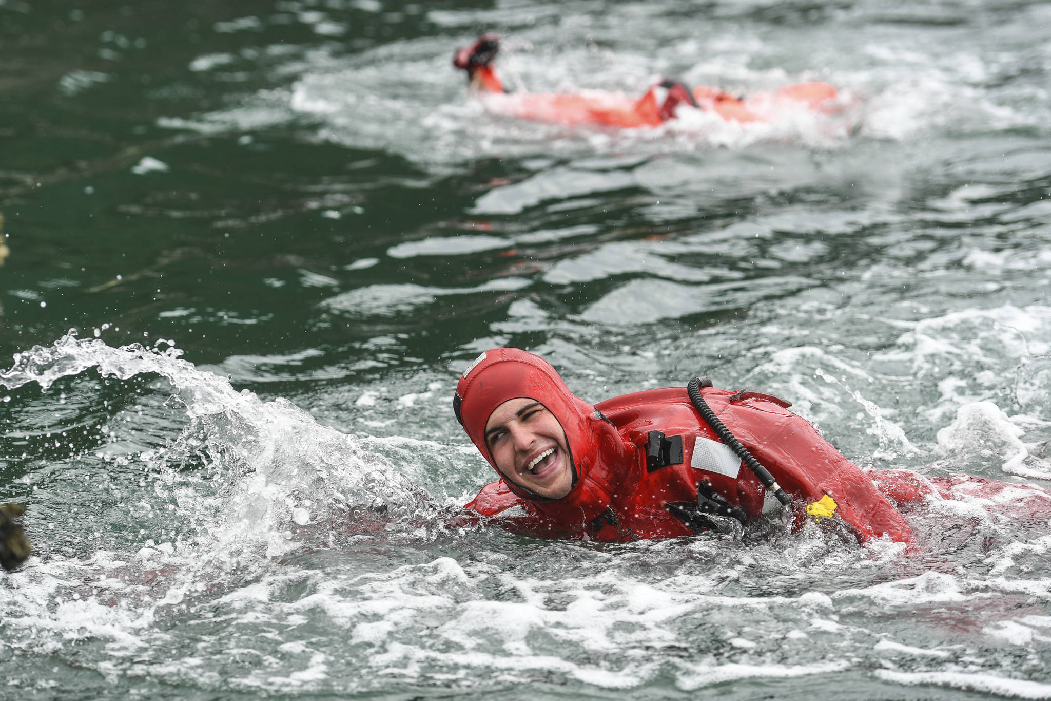 Seaman Weston Murdock of the U.S. Coast Guard Cutter Henry Blake, competes in the survival suit swim during the annual Buoy Tender Olympics at Station Juneau on Wednesday, Aug. 21, 2019. (Michael Penn | Juneau Empire)
