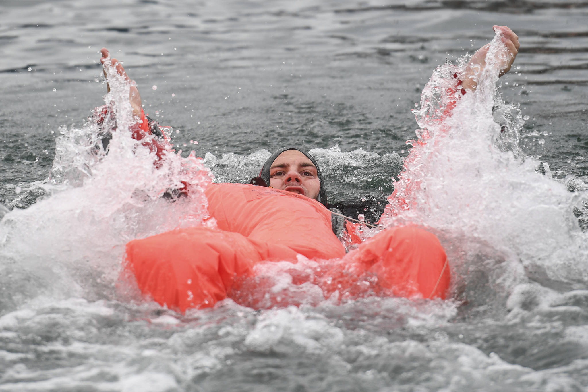 Brett Hyde, of the U.S. Army Dive Team, competes in the survival suit swim during the annual Buoy Tender Olympics at Station Juneau on Wednesday, Aug. 21, 2019. (Michael Penn | Juneau Empire)