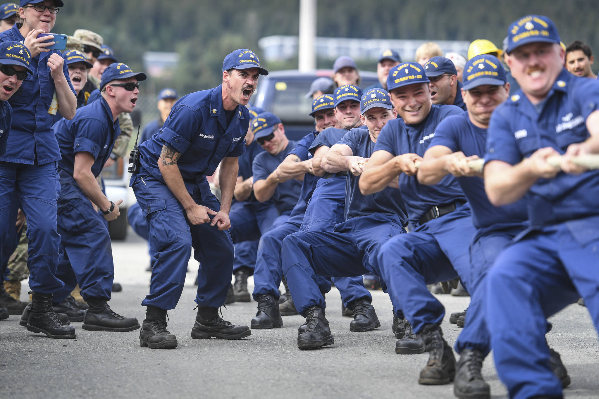 Marcos Saldarriaga, of the U.S. Coast Guard Cutter Kukui, center, shouts encouragement to his teammates as they compete in a tug of war contest during the annual Buoy Tender Olympics at Station Juneau on Wednesday, Aug. 21, 2019. (Michael Penn | Juneau Empire)