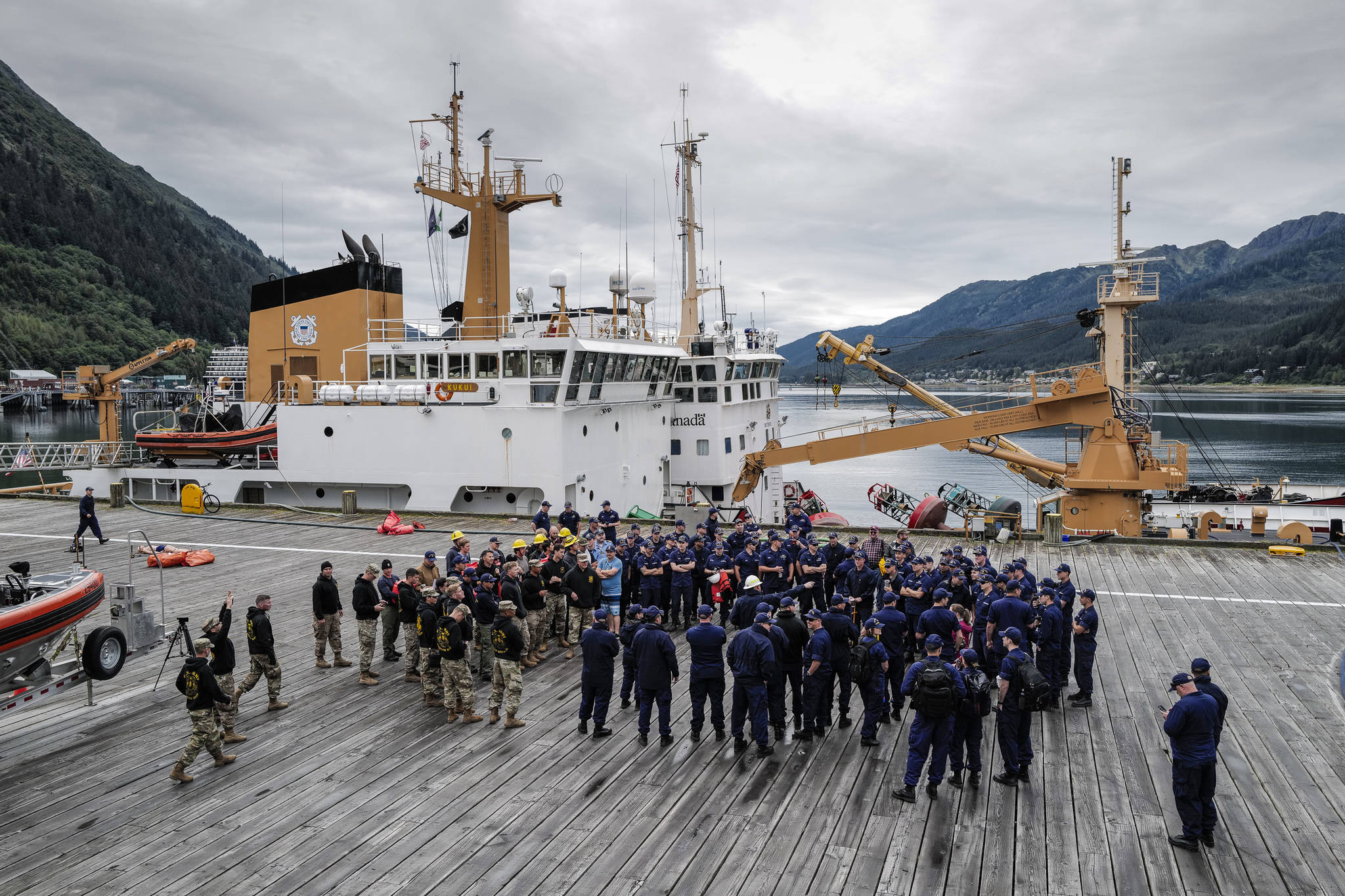 Members of the U.S. Coast Guard, U.S.C.G Dive Team, U.S. Army Dive Team and the Canadian Coast Guard gather for the annual Buoy Tender Olympics at Station Juneau on Wednesday, Aug. 21, 2019. (Michael Penn | Juneau Empire)