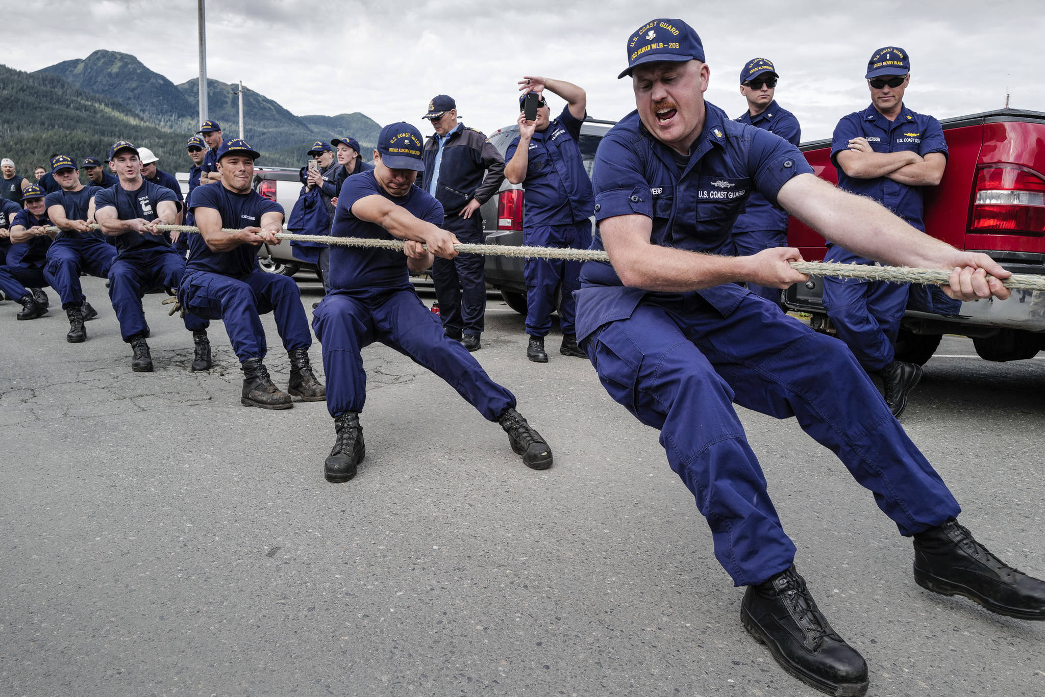 Dylan Webb, of the U.S. Coast Guard Cutter Kukui, right, fronts his team in a tug of war contest during the annual Buoy Tender Olympics at Station Juneau on Wednesday, Aug. 21, 2019. (Michael Penn | Juneau Empire)