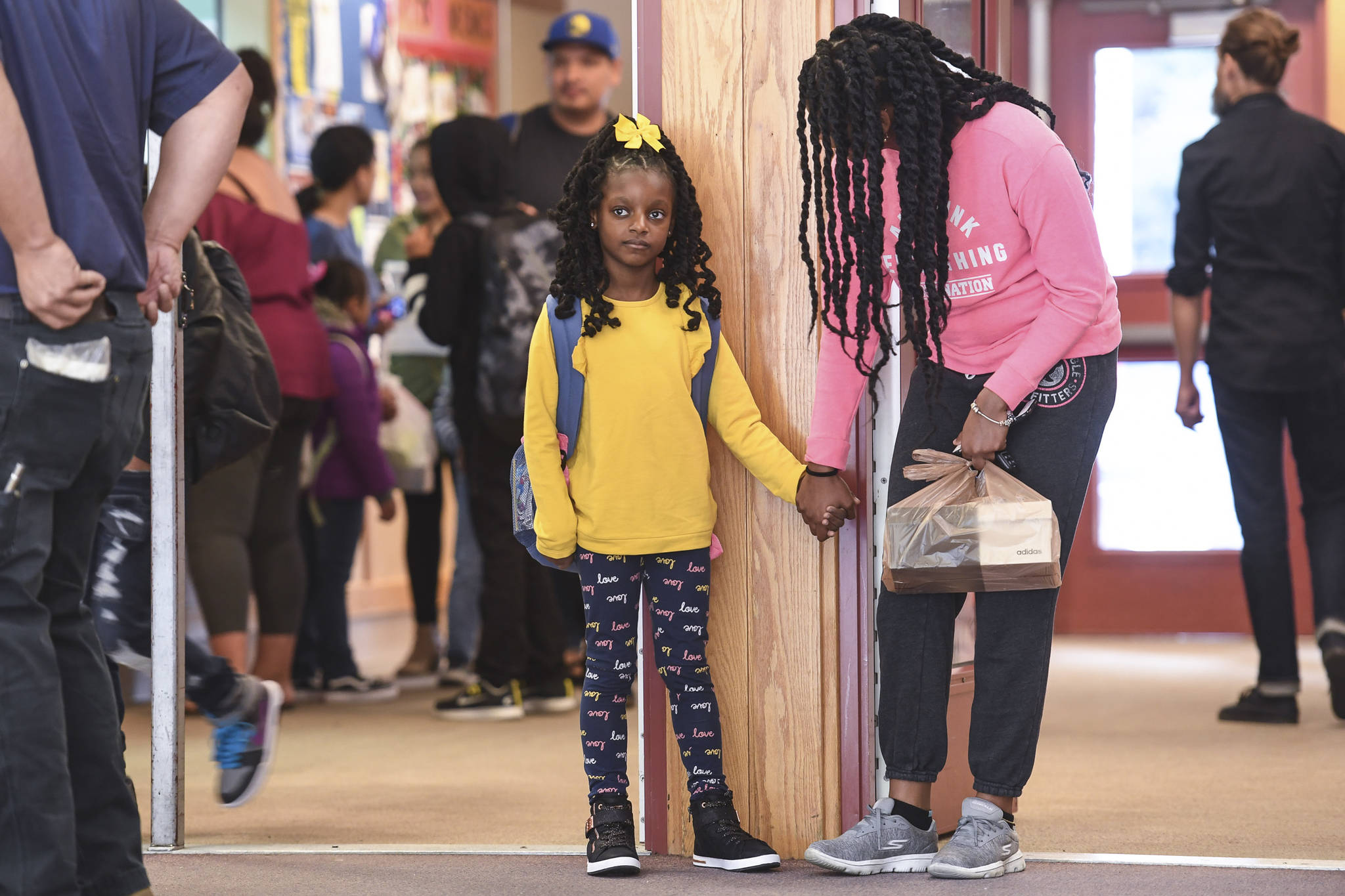 Ariyah Allen, holds hands with her mother, Odette, after arriving for the first day of school at Riverbend Elementary School on Monday, Aug. 19, 2019. (Michael Penn | Juneau Empire)