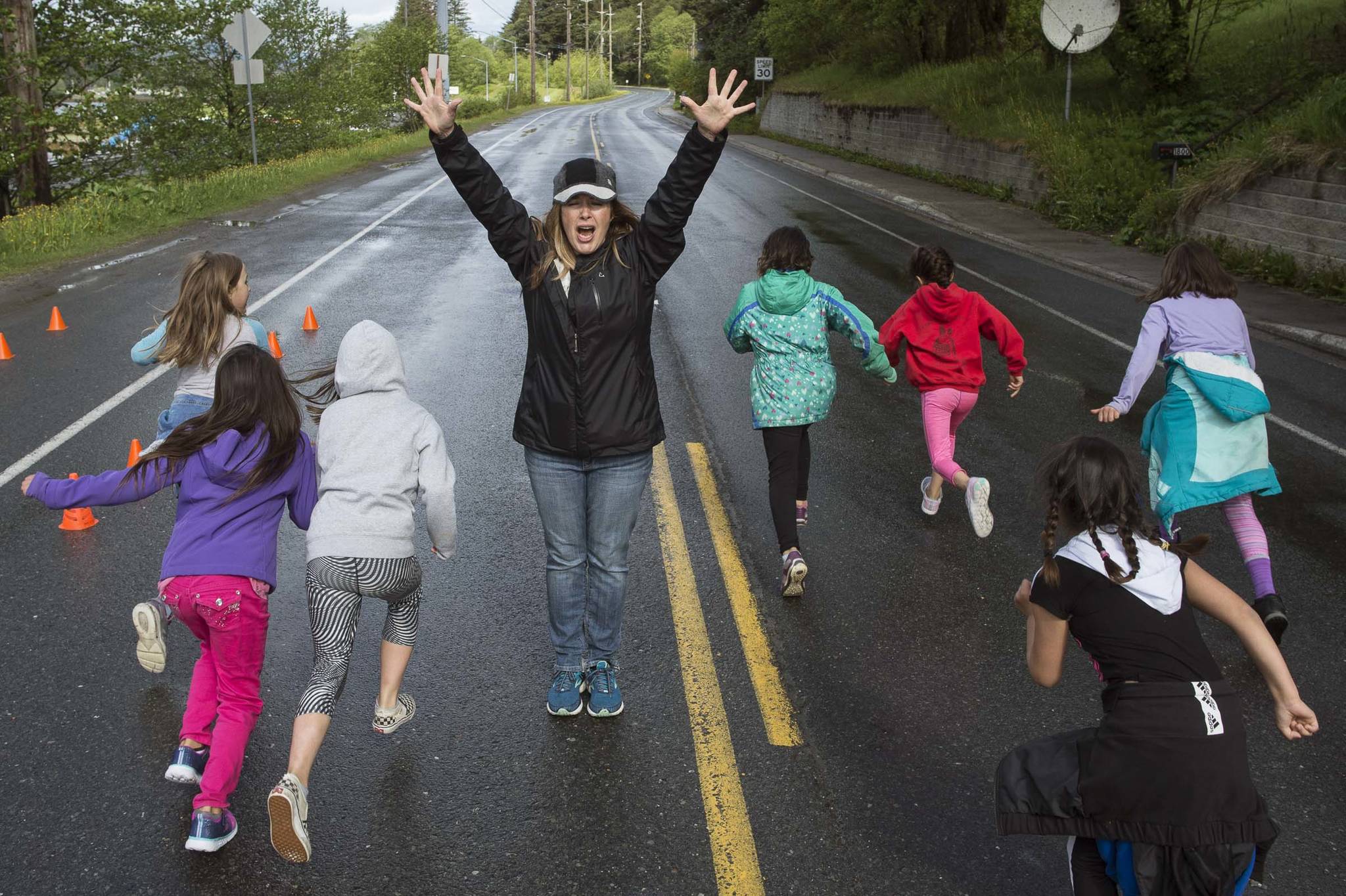 Physical Education Teacher Nikki Richert send students off for Harborview Elementary School’s annual Fun Run along Glacier Avenue on Friday, May 17, 2019. Students from Montessori Borealis also ran the three mile course. (Michael Penn | Juneau Empire)