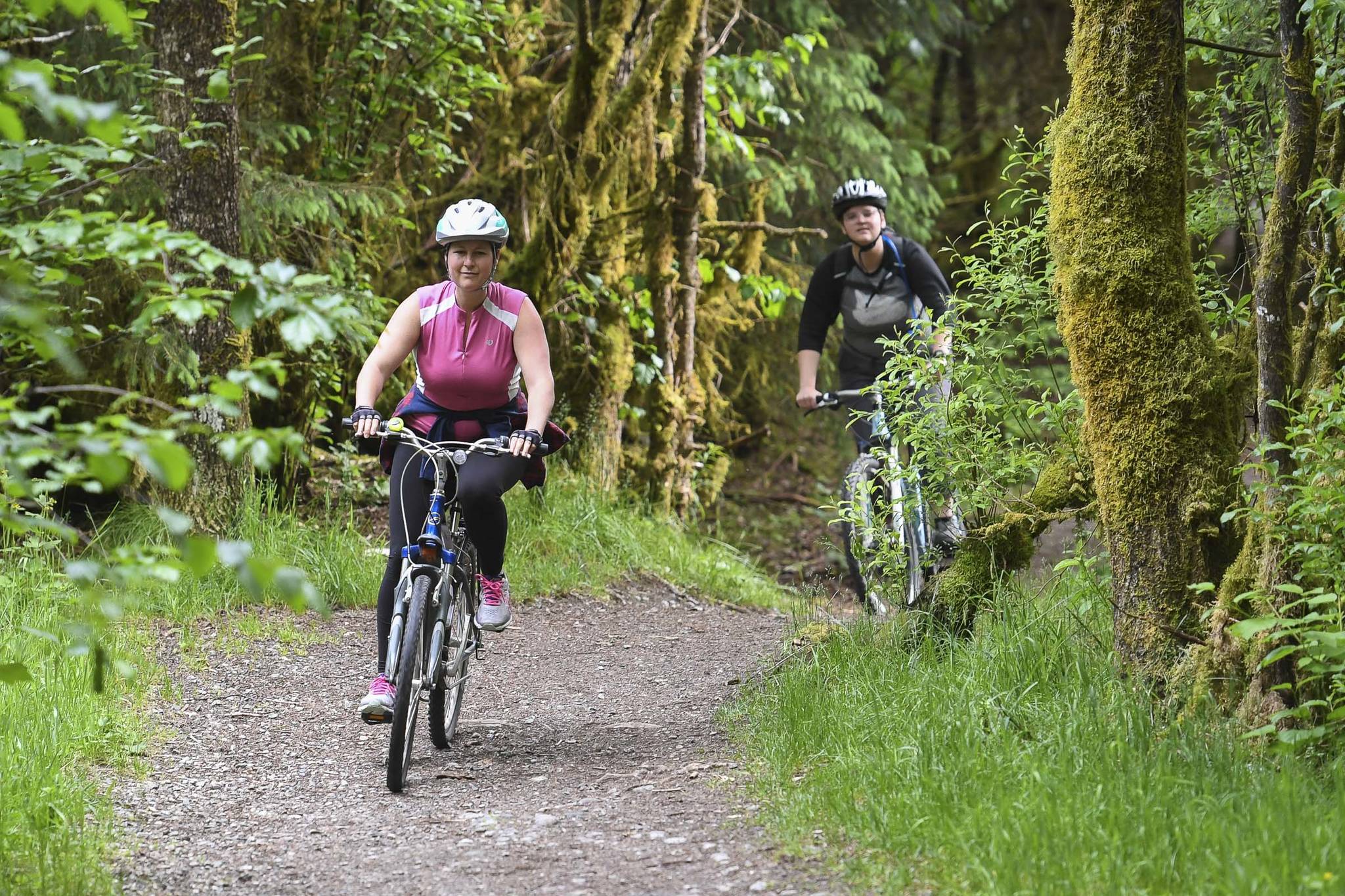 Tana O’Leary, left, rides her mountain bicycle with Nicole Dwyer during a women’s mountain bike ride at Dredge Lakes on Thursday, June 13, 2019. (Michael Penn | Juneau Empire)