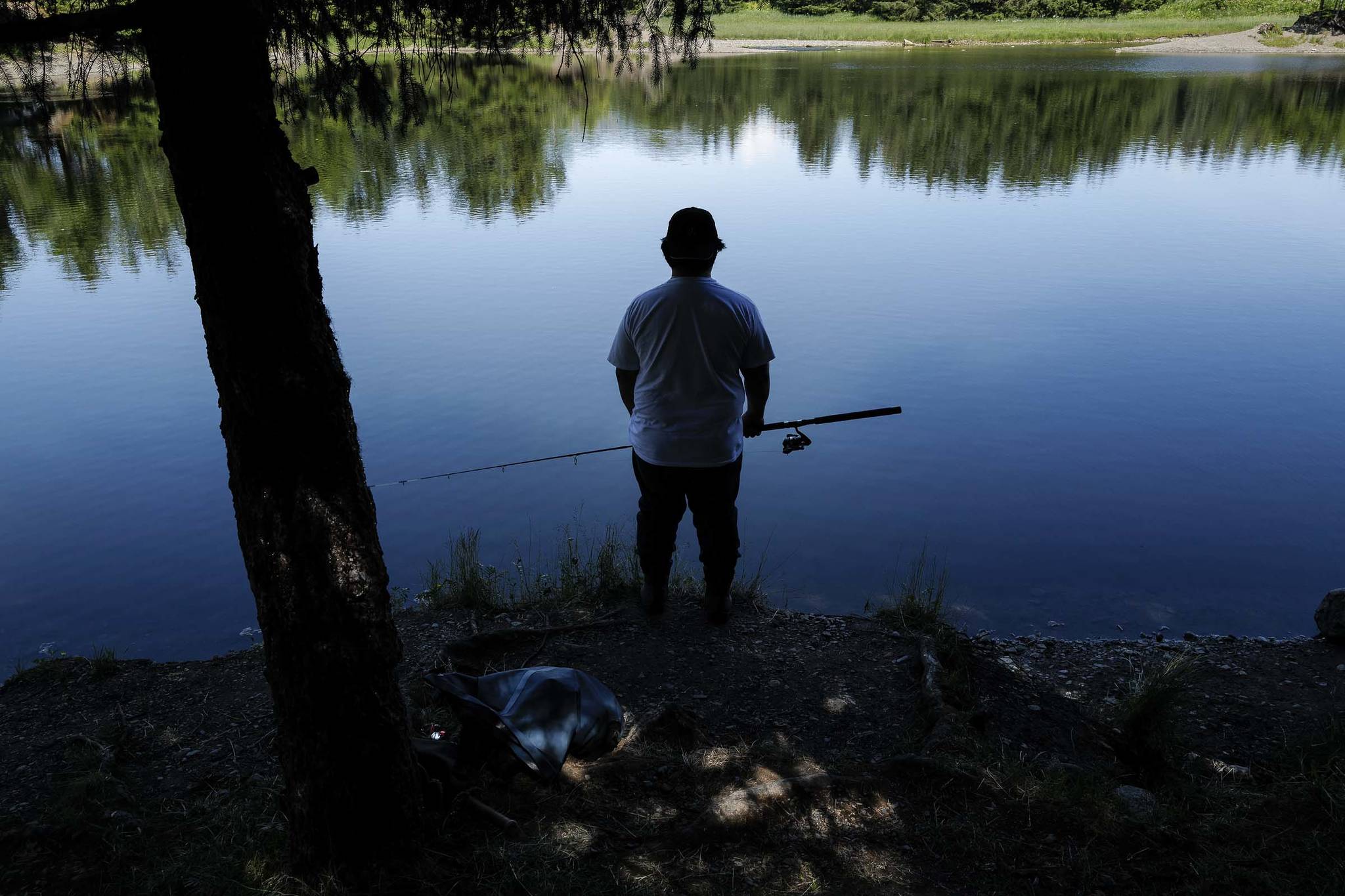 Kyle Wales waits and watches for a king salmon to rise in the Fish Creek Pond on Tuesday, June 25, 2019. (Michael Penn | Juneau Empire)