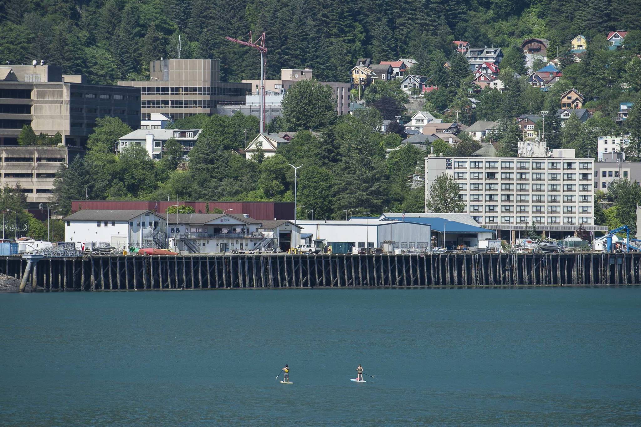 Lionel Uddipa and Tessany Alrich explore Juneau’s downtown harbor by paddleboard on Thursday, June 27, 2019. (Michael Penn | Juneau Empire)
