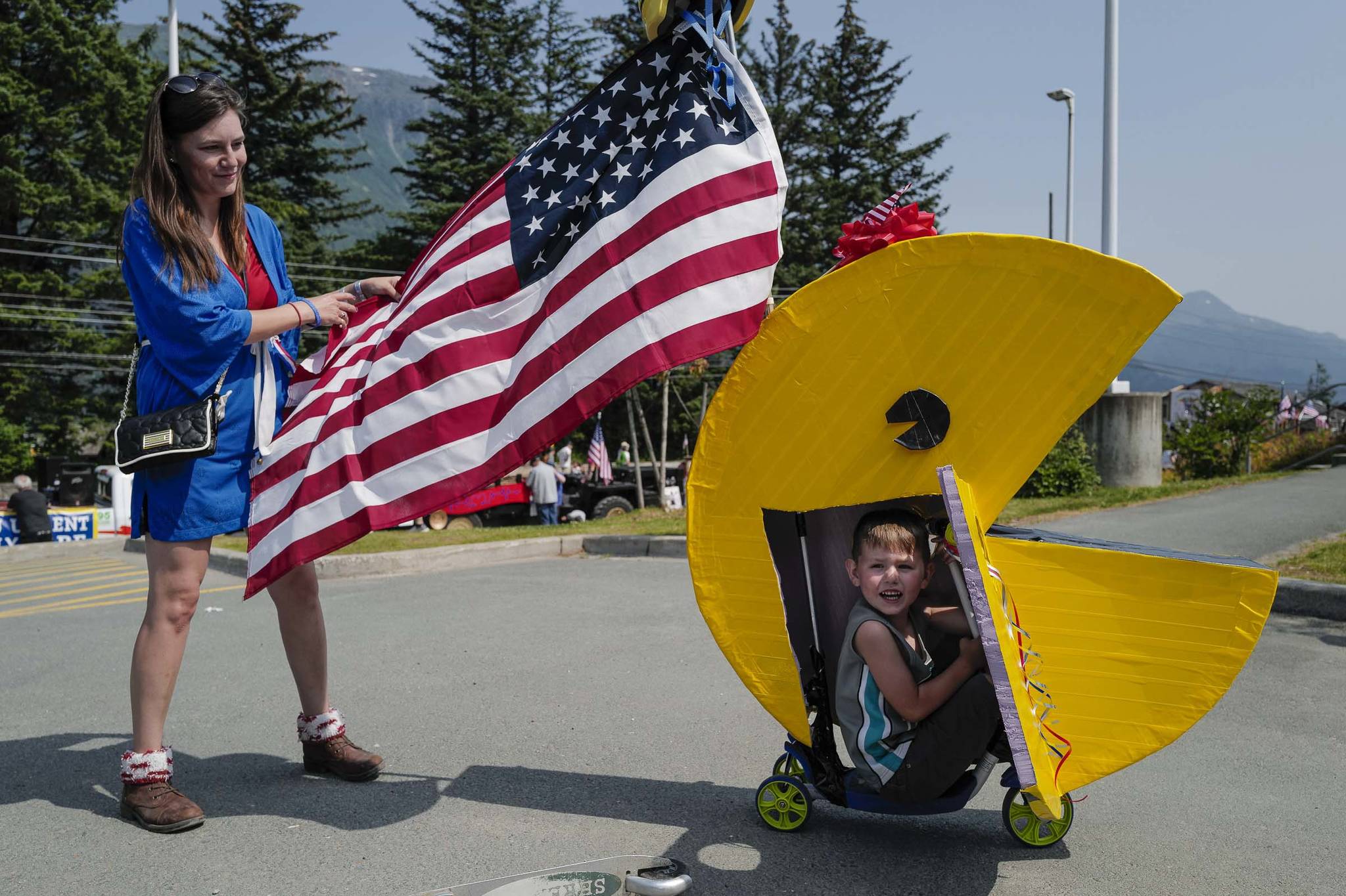 Joseph Kinville, 4, and his mother, Jessica, prepare for the Douglas Fourth of July Parade on Thursday, July 4, 2019. Joseph won $5 for the best boys decorated bicycle in the character division by the Douglas Fourth of July Committee. (Michael Penn | Juneau Empire)