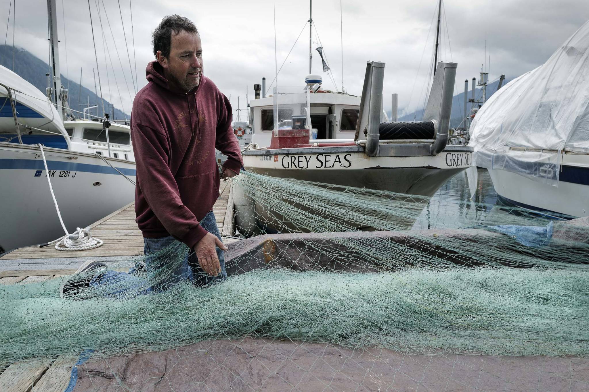 Albert McDonald works on his salmon gillnet in front of his bowpicker “Grey Seas” at Aurora Harbor on Friday, July 12, 2019. McDonald worked as a deckhand for 20 years before buying his own boat in 2003. He said he mainly fishes in Taku Inlet. (Michael Penn | Juneau Empire)