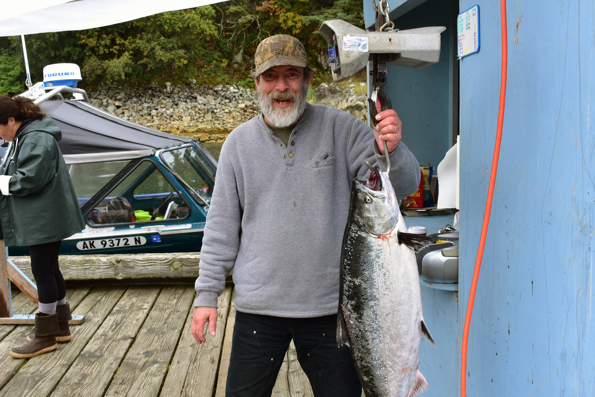 Steven Bogert stands next to his 24-pound king salmon Sunday at the Mike Pusich Douglas Harbor. (Peter Segall | Juneau Empire)