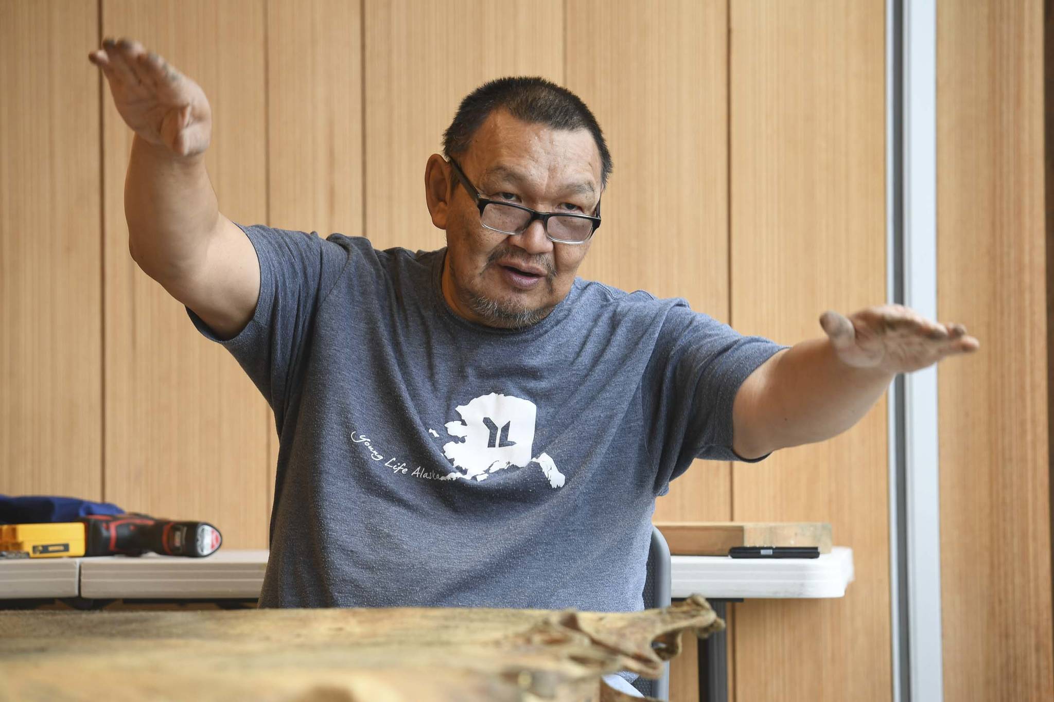 John Waghiyi, Jr. artist and whaling captain, talks about preparing a walrus hide as he sews a blanket at the Walter Soboleff Center on Tuesday, Aug. 27, 2019. the Waghiyis will demonstrate dances from their region from noon-1 pm, Wednesday, Aug. 28, for the public at SHI. (Michael Penn | Juneau Empire)