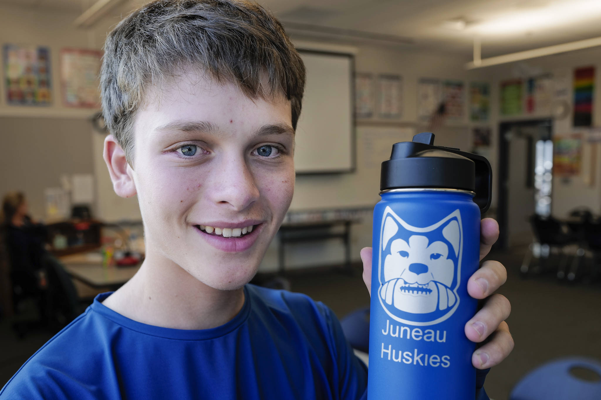 Alain Soltys-Gray, a sophomore at Thunder Mountain High School, displays his logo design for the Juneau Huskies football team at TMHS on Wednesday, Aug. 28, 2019. (Michael Penn | Juneau Empire)
